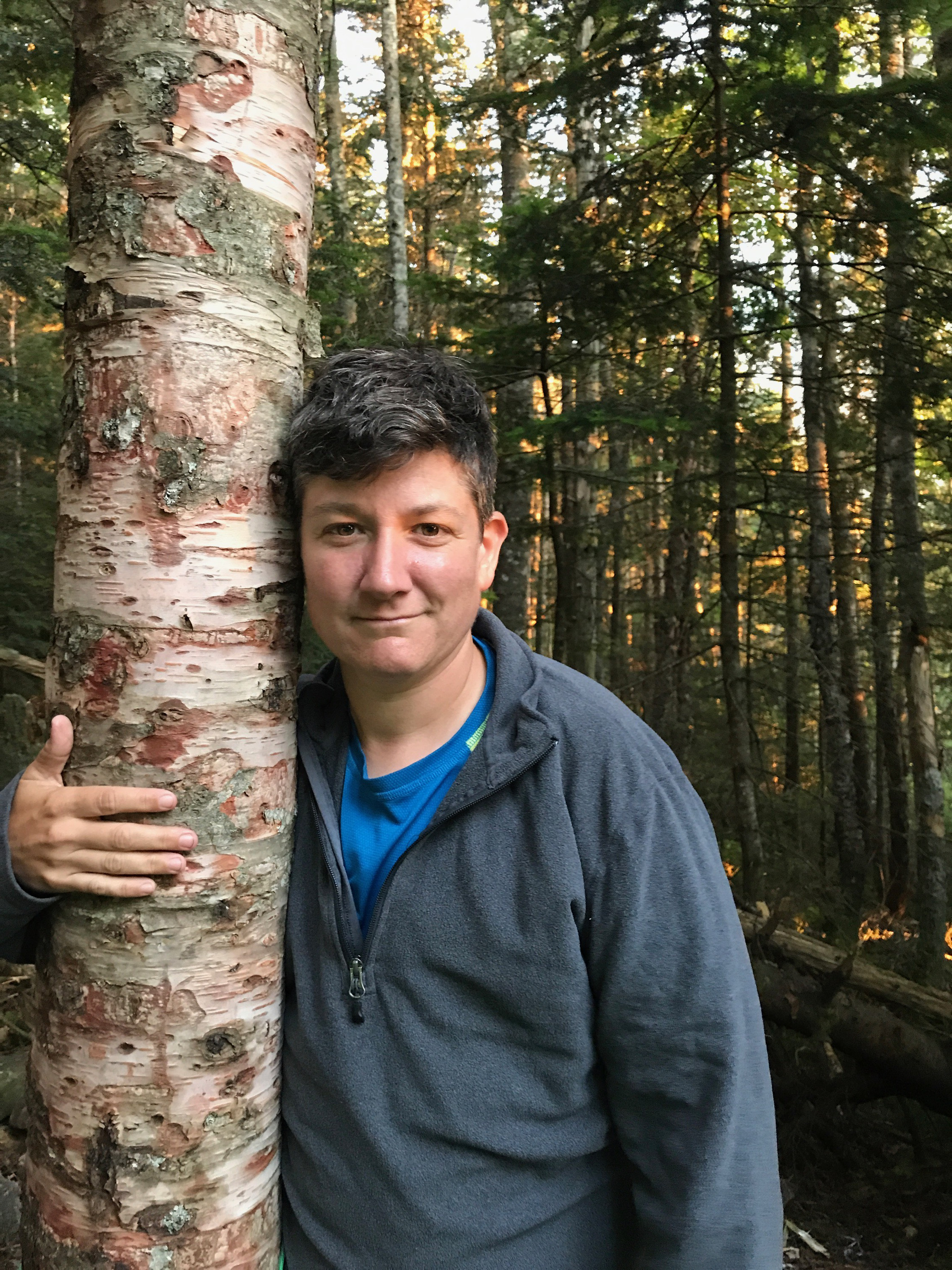 Certified forest therapy guide Tam Willey in the woods last summer.