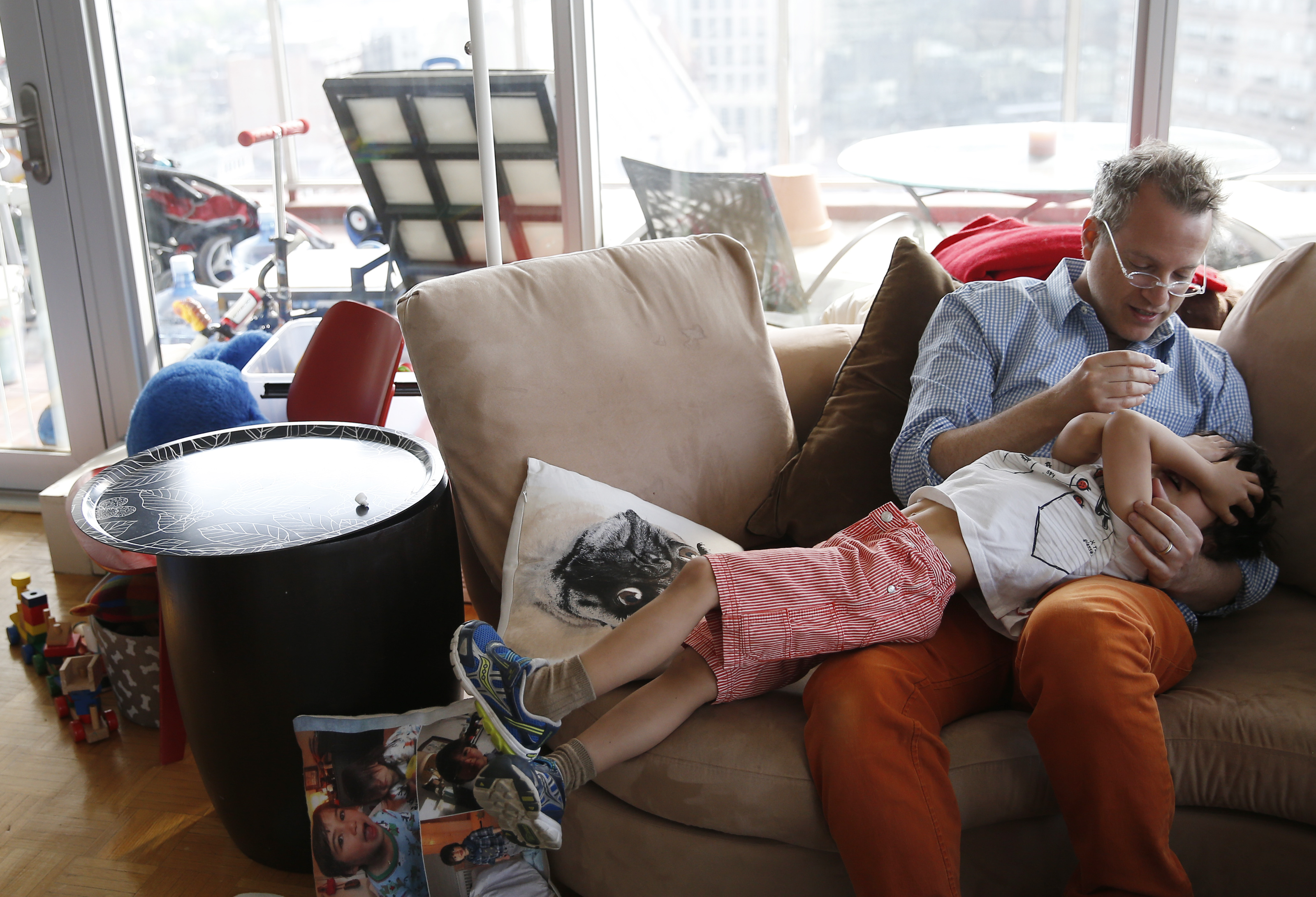 <b>7:54 a.m.</b> Mezrich tries to apply eye drops to his son Asher’s eyes to help soothe his allergies.