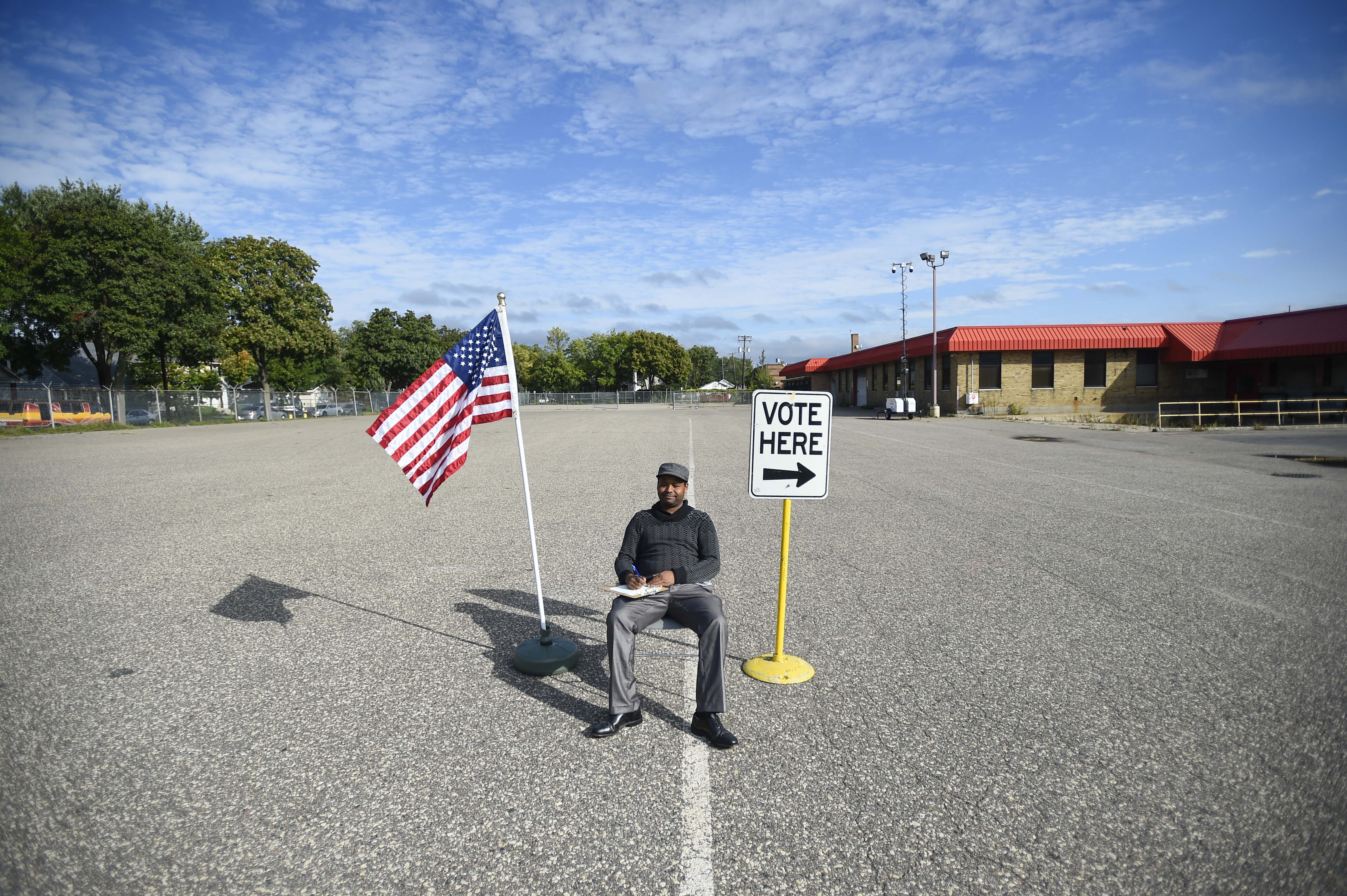Poll judge Chala Alemo was stationed in the middle of a large parking lot to direct voters to the correct entrance of a former home repair store that is now an early vote center, one of four early-vote locations in Minneapolis.