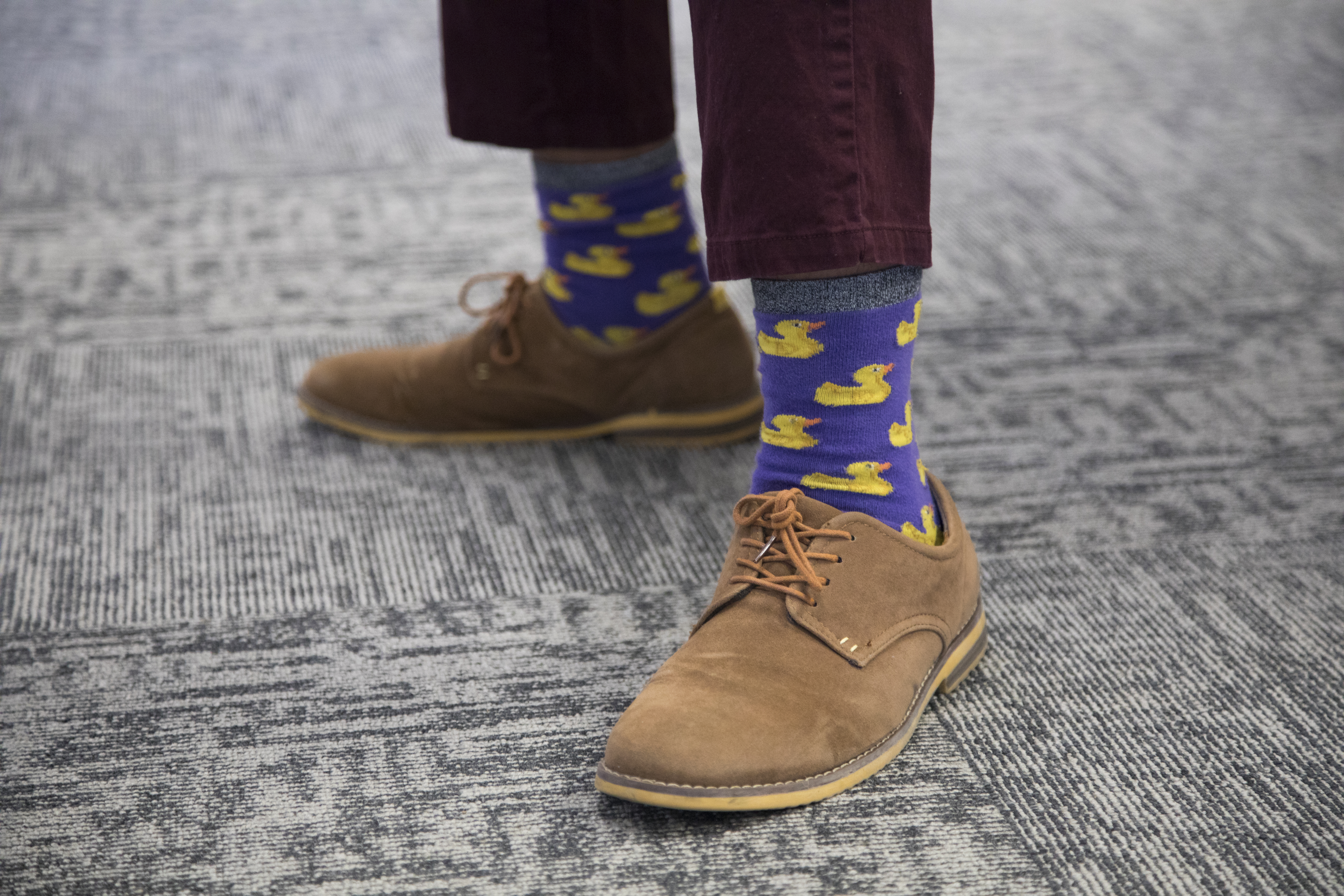 Tahir Quee shows off his duck socks on a Formal Thursday at Reveneer in Woburn.