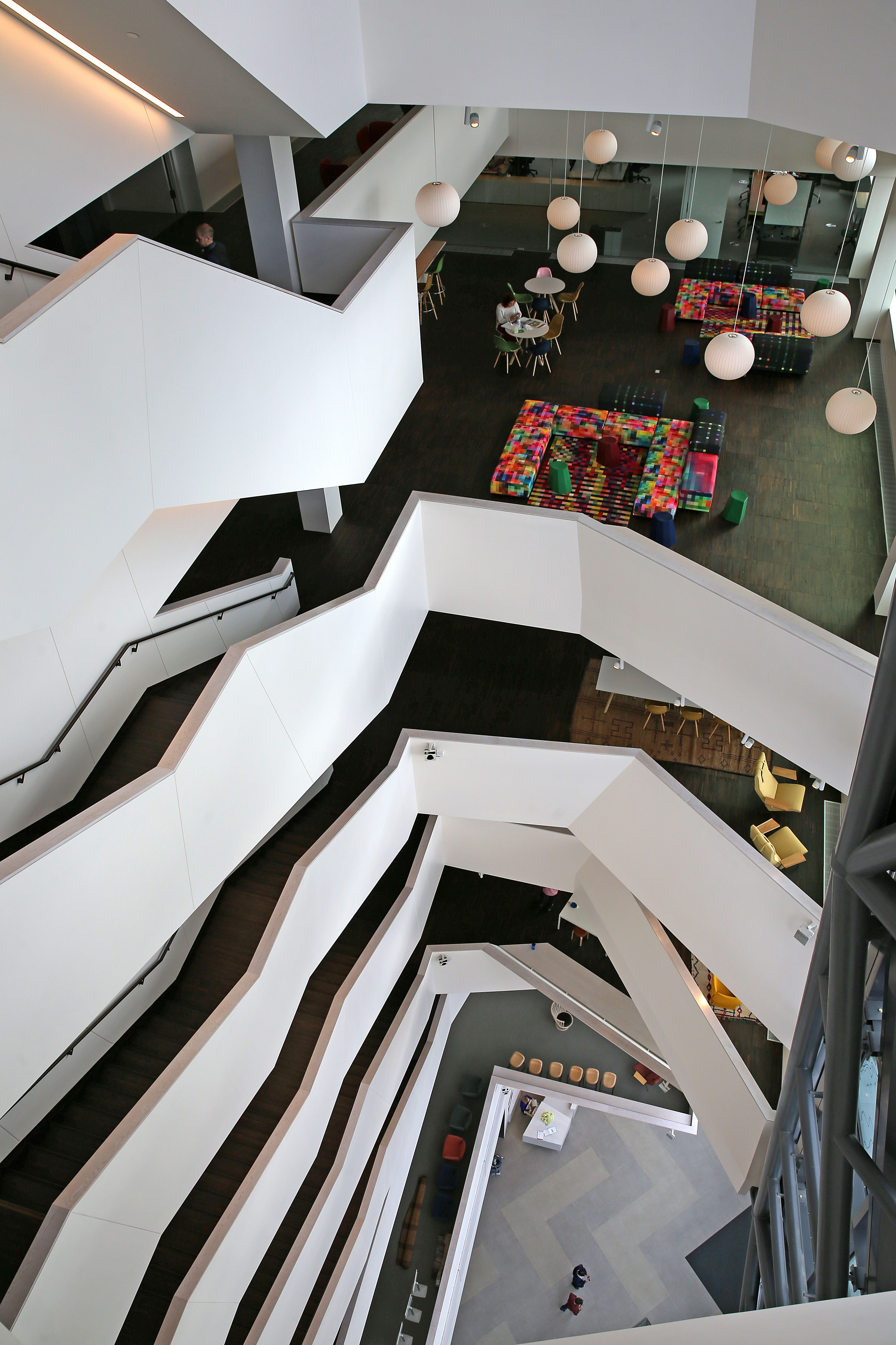The building features an open staircase that serves all 10 floors and a glass-clad exterior.