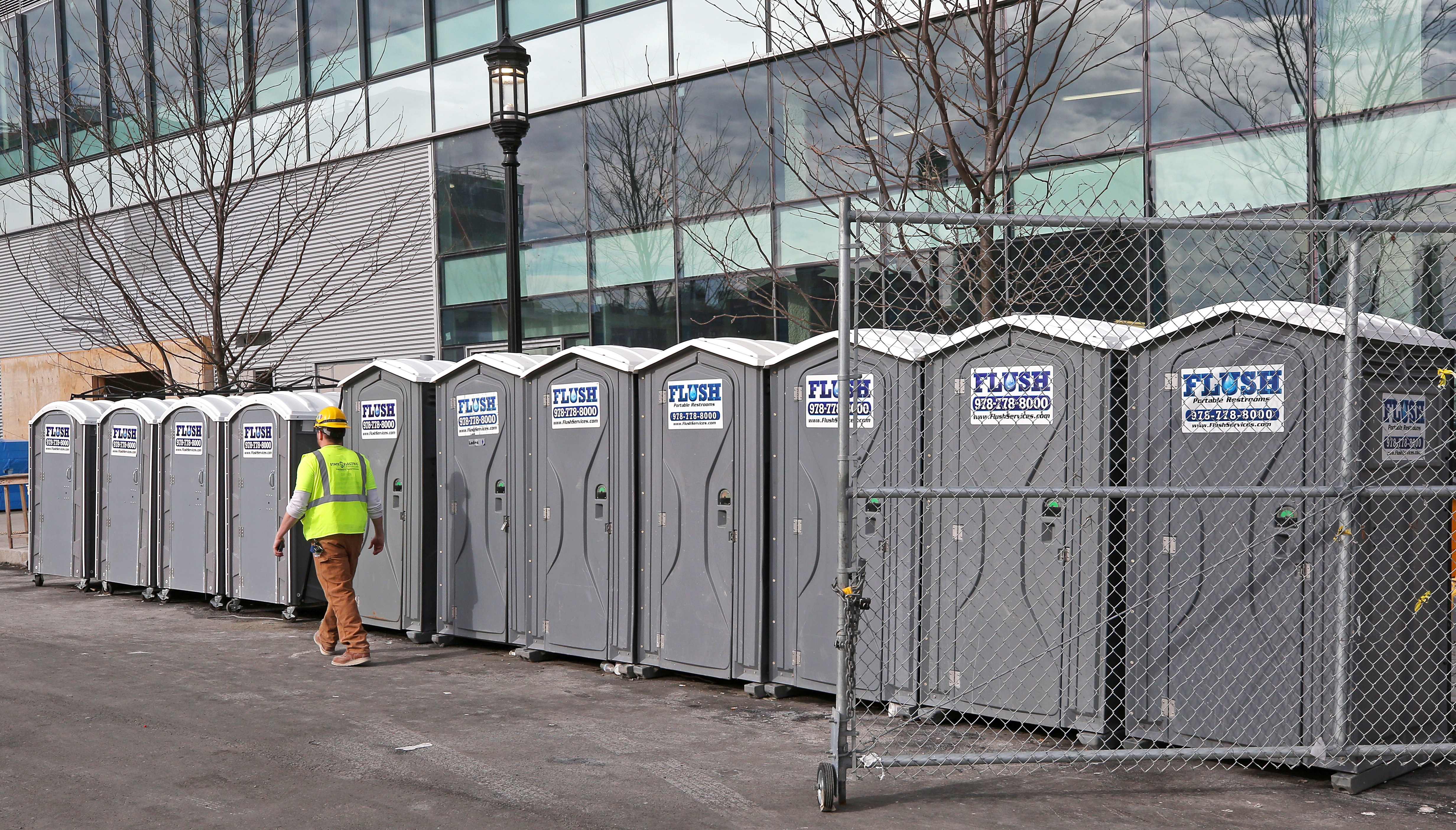 A row of porta-potties at a construction site at 121 Seaport.