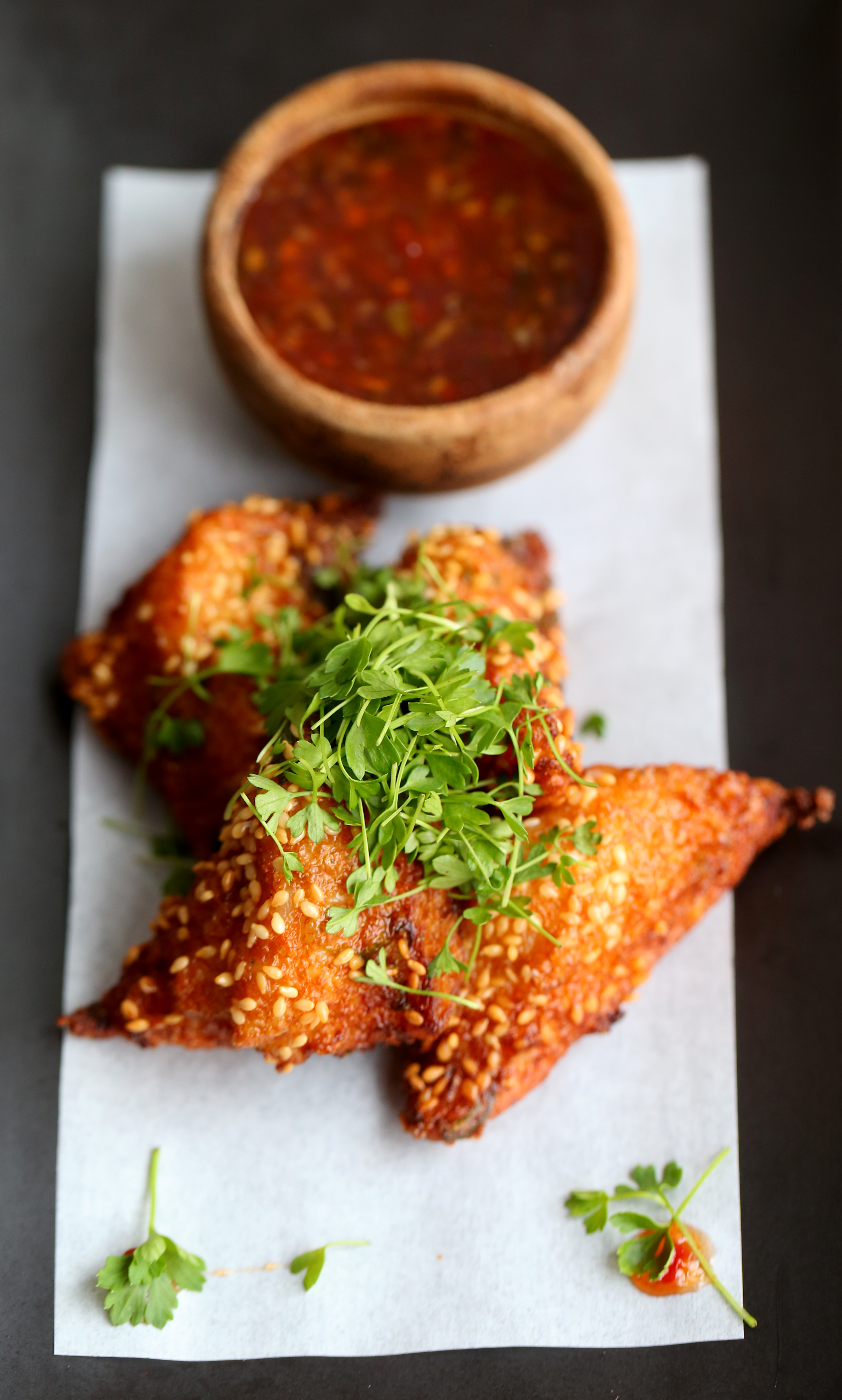 In Waltham, Red Bird’s crispy sesame shrimp toast with homemade sambal, and celery greens.