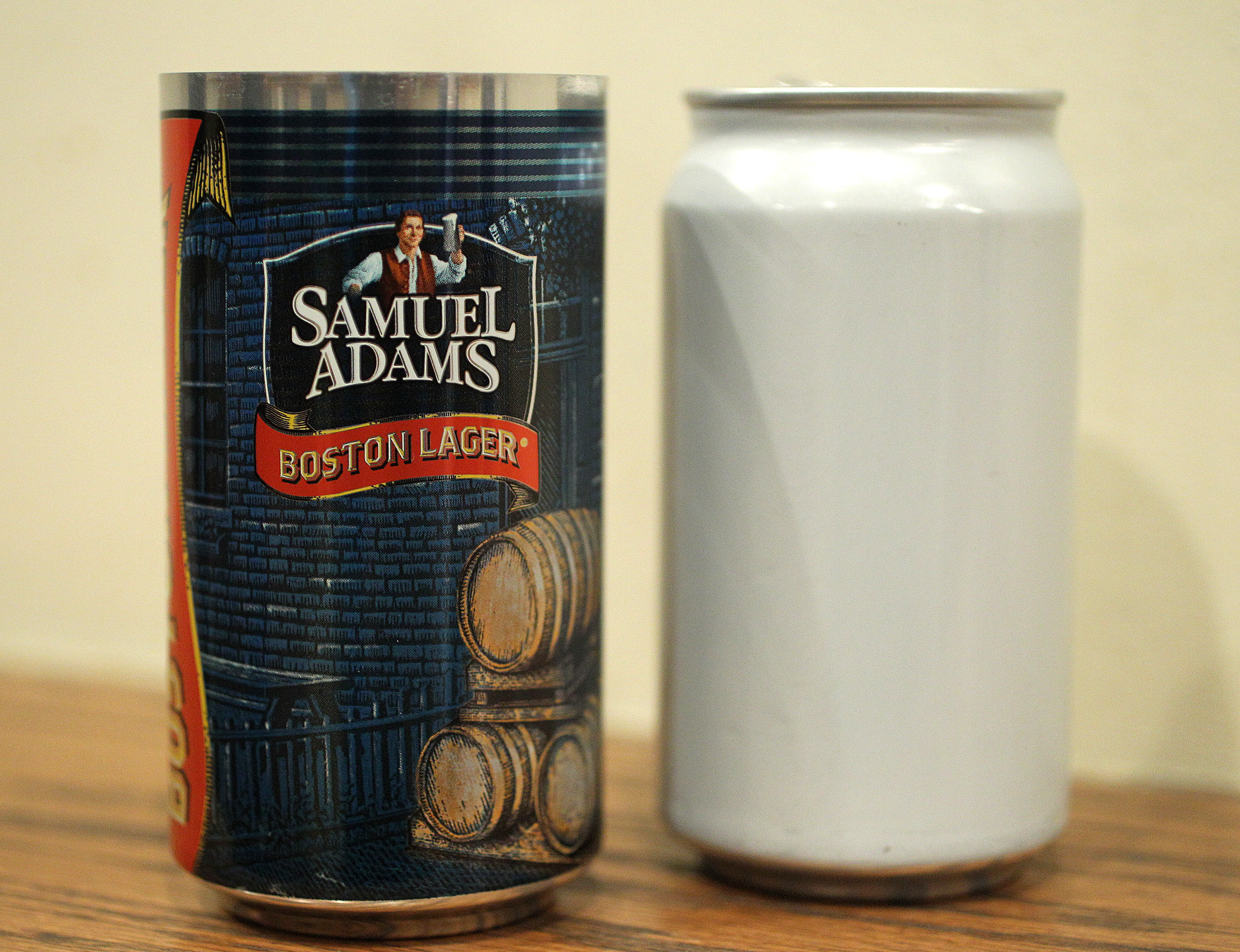 Boston, MA--2/14/2013--A proposed print design, left, is next to the newly developed can. At the Sam Adams Brewery, Roy Desrochers (cq) (sensory practice leader with GEI Consultants, Inc.) and Jim Koch (cq) (brewer/founder Sam Adams) discuss the development of a can for the beer, on Thursday, February 14, 2013. Photos by Pat Greenhouse/Globe Staff Topic: beercan Reporter: J Abelson
