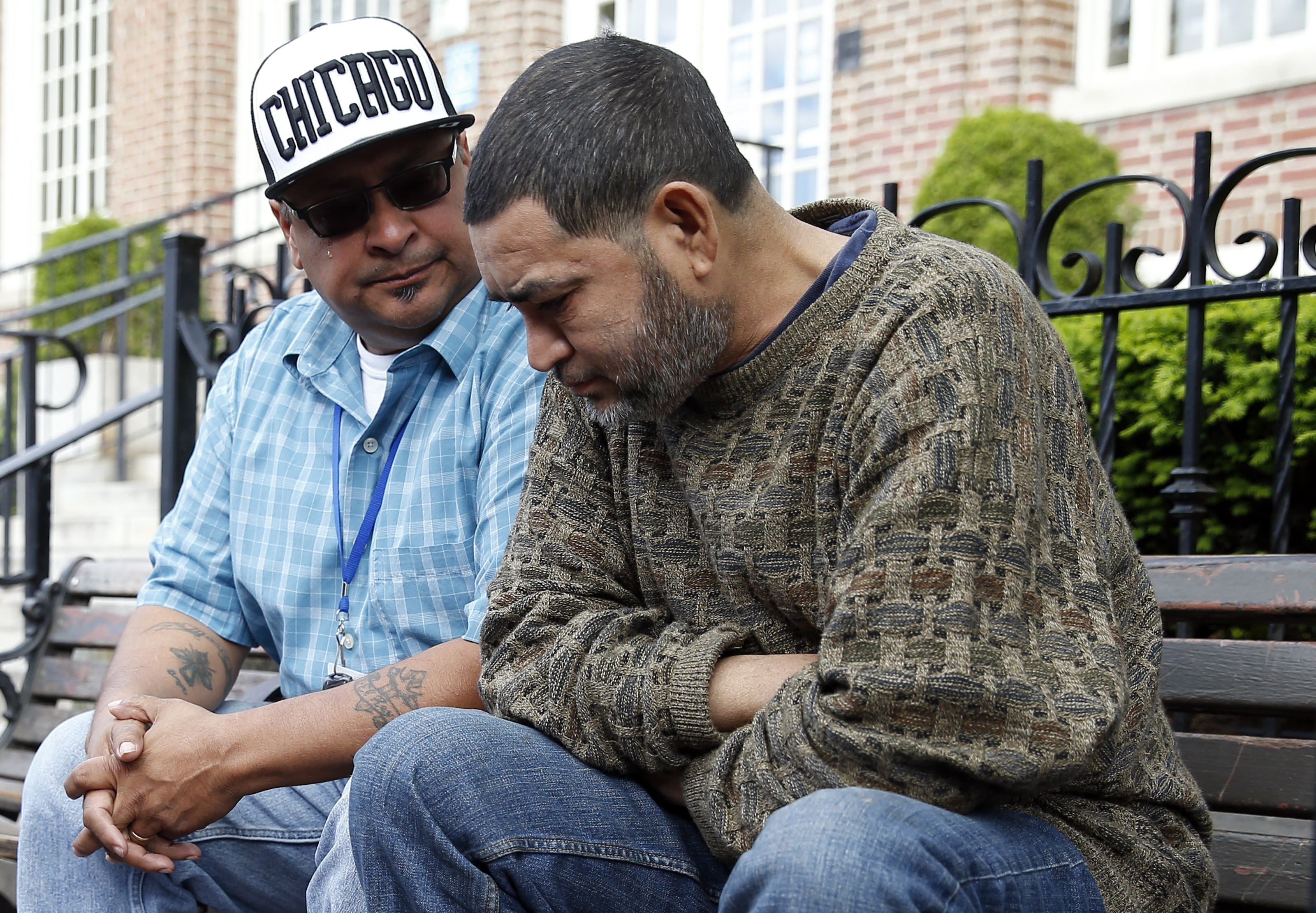 Outreach worker Ruben Rodriguez (left) teared up as he talks to a man in Bellingham Square about his struggles with alcohol.