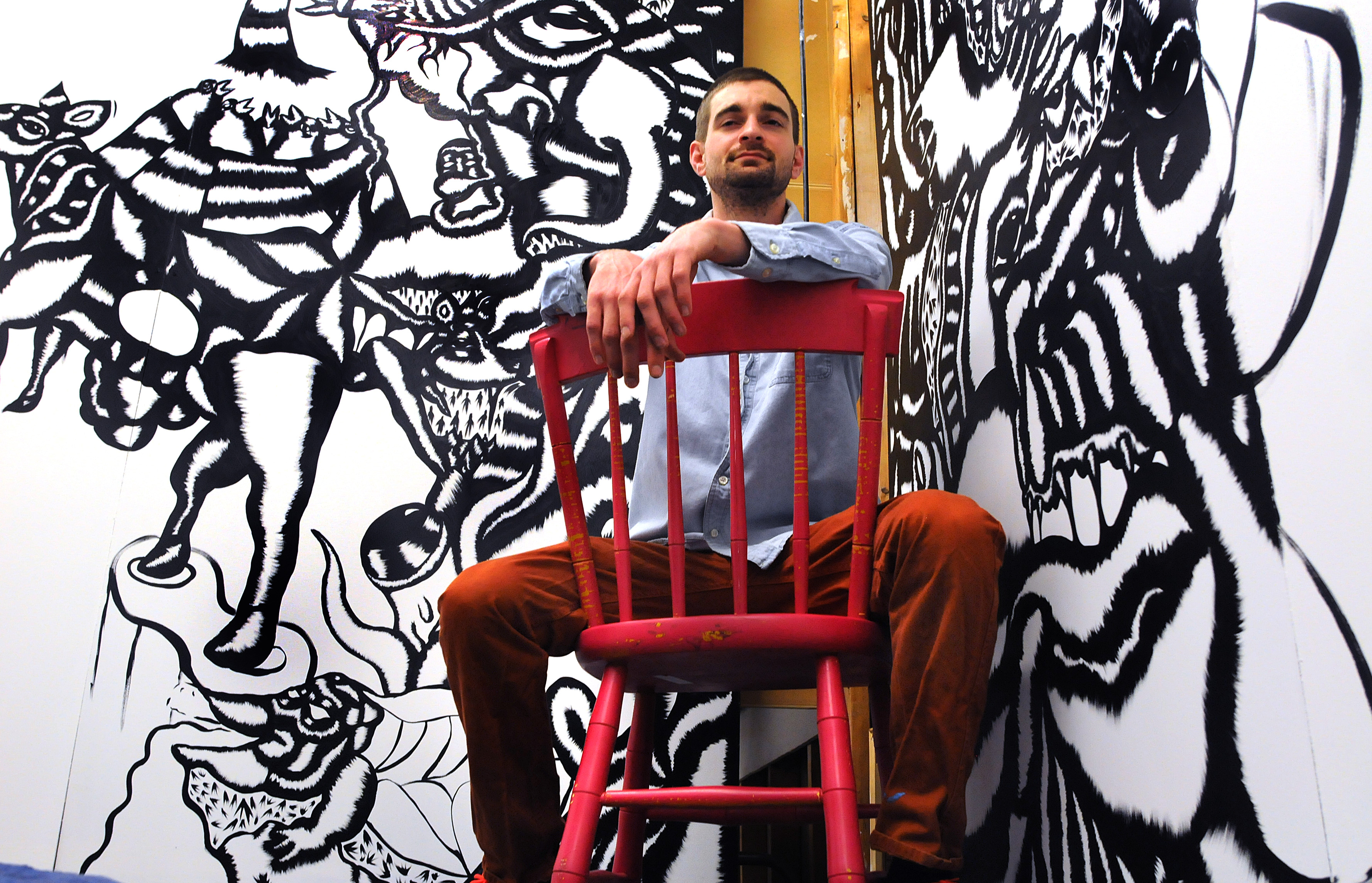 Boston 04/19/2014 - Artist Chase Brannock sits infront of his untitled black-and-white mural at the Museum School studios. Photo by Debee Tlumacki for the Boston Globe (arts) Reporter: Cate McQuaid