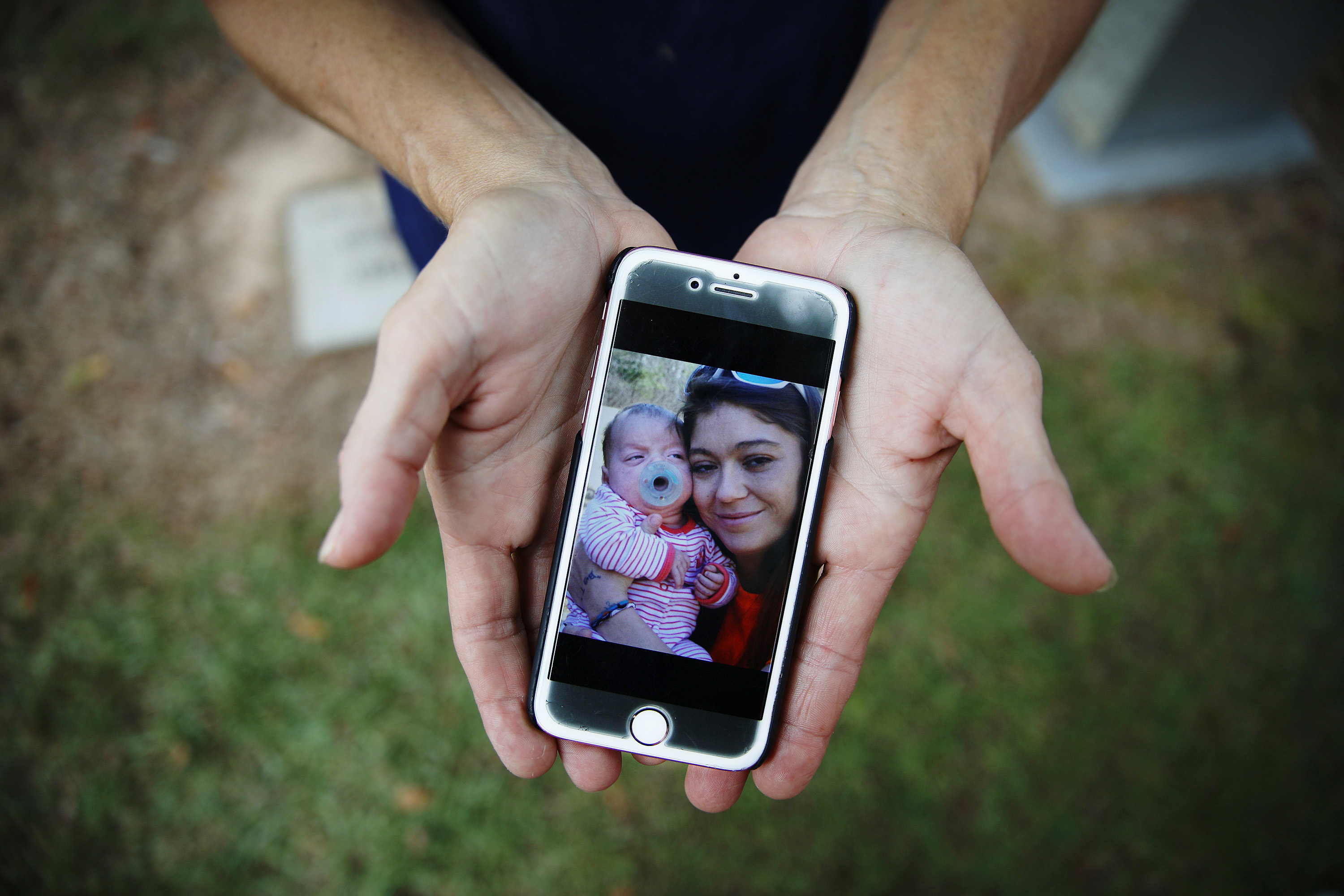 Angel Wade displayed a photo of her daughter, Tami Mann, and baby Jasmine.