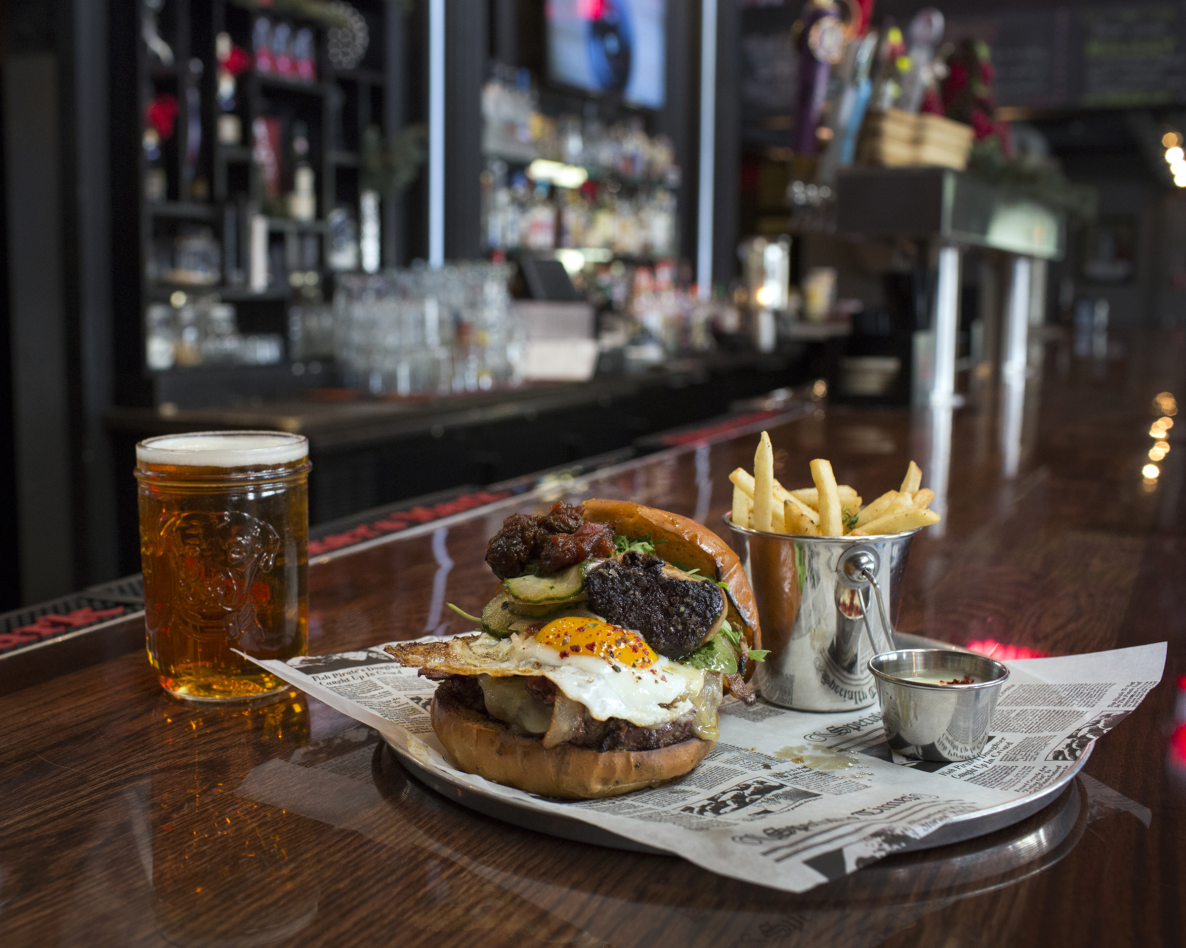 In Acton, the Red Raven Gastropub’s Black Angus beef on a black pepper brioche bun with a fried egg, smoked applewood bacon, and foie gras.
