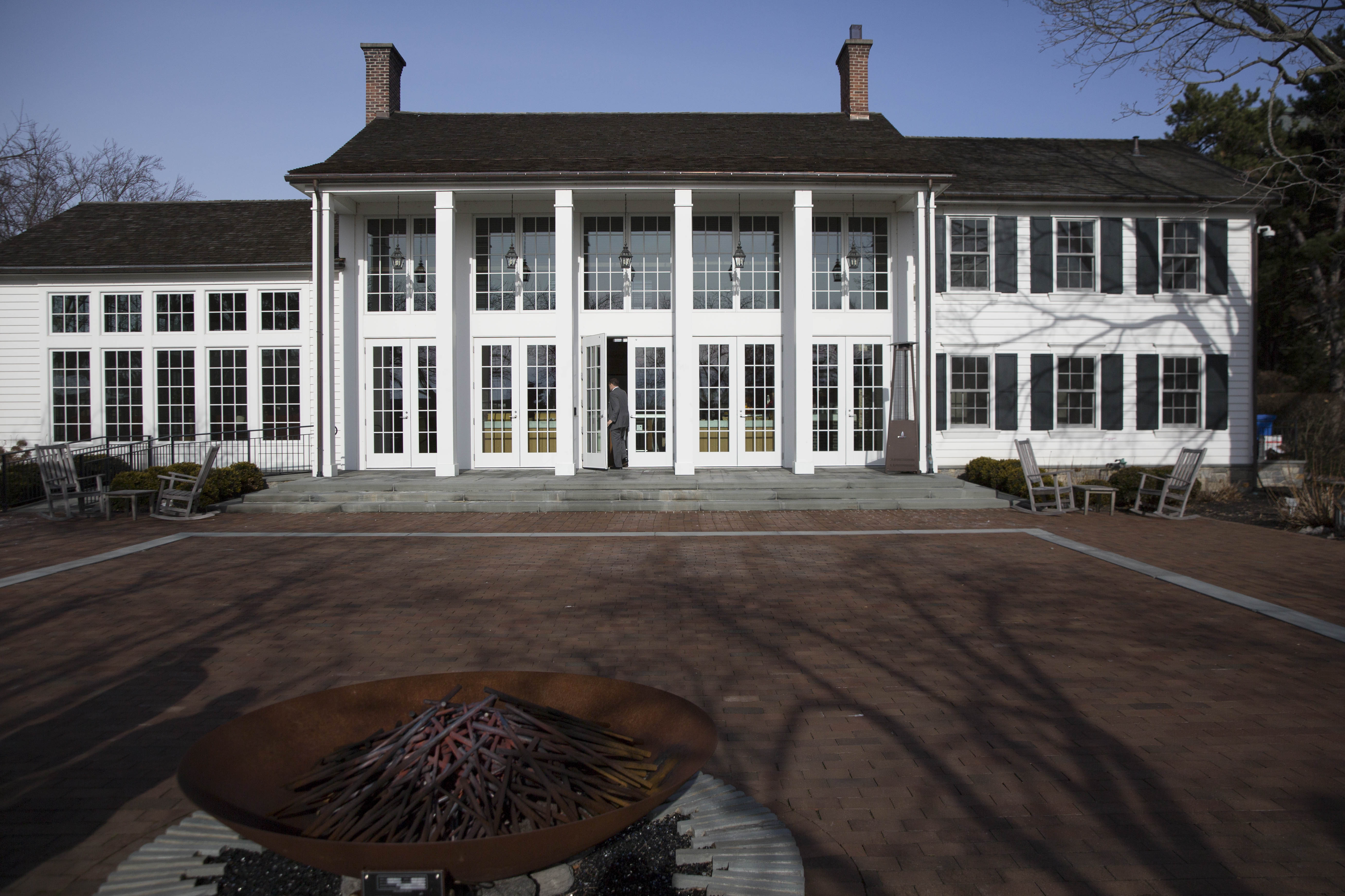The exterior of Cafe 56 with a fire pit in the foreground.