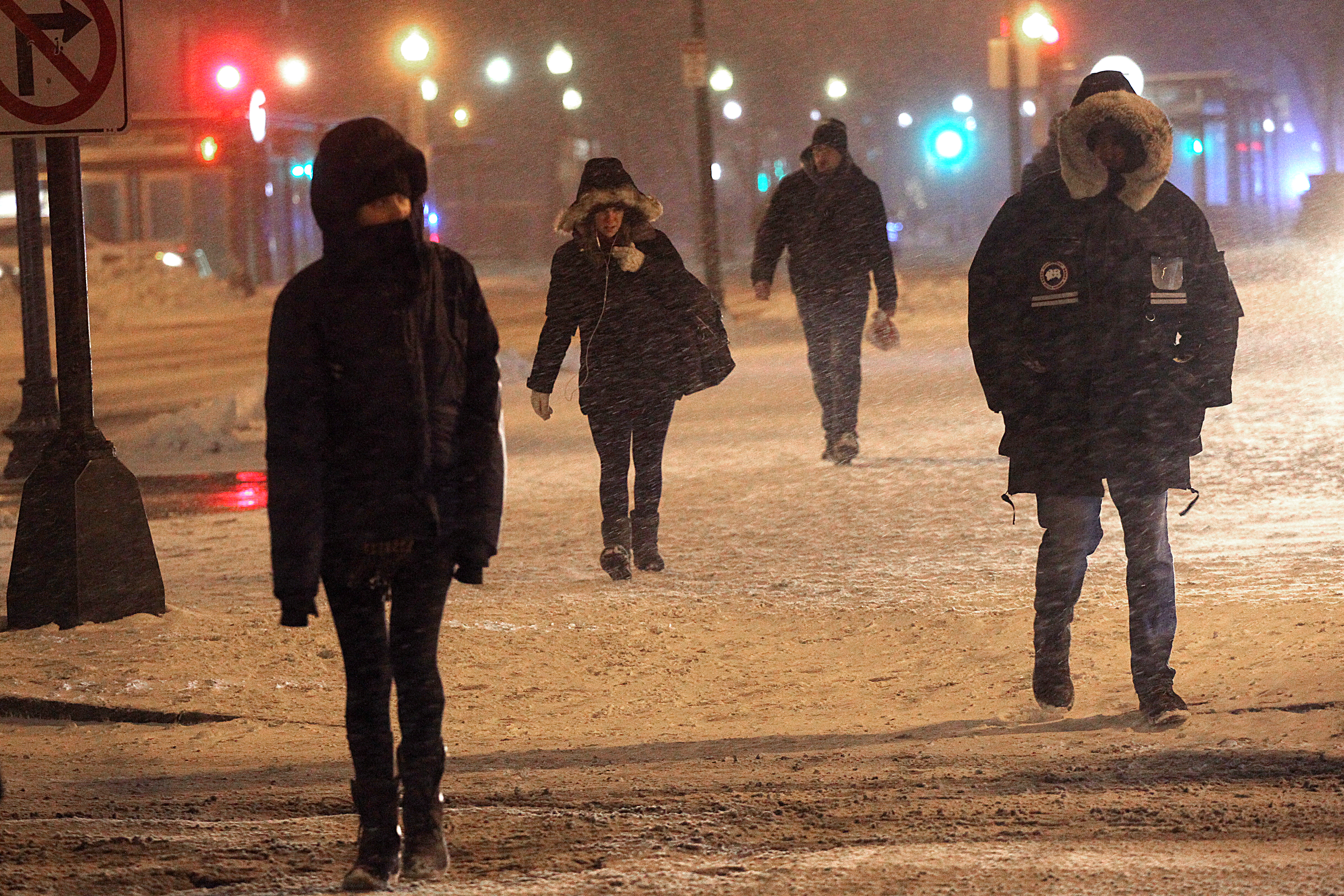 Pedestrians struggled with the wind and snow in Copley Square in Boston.