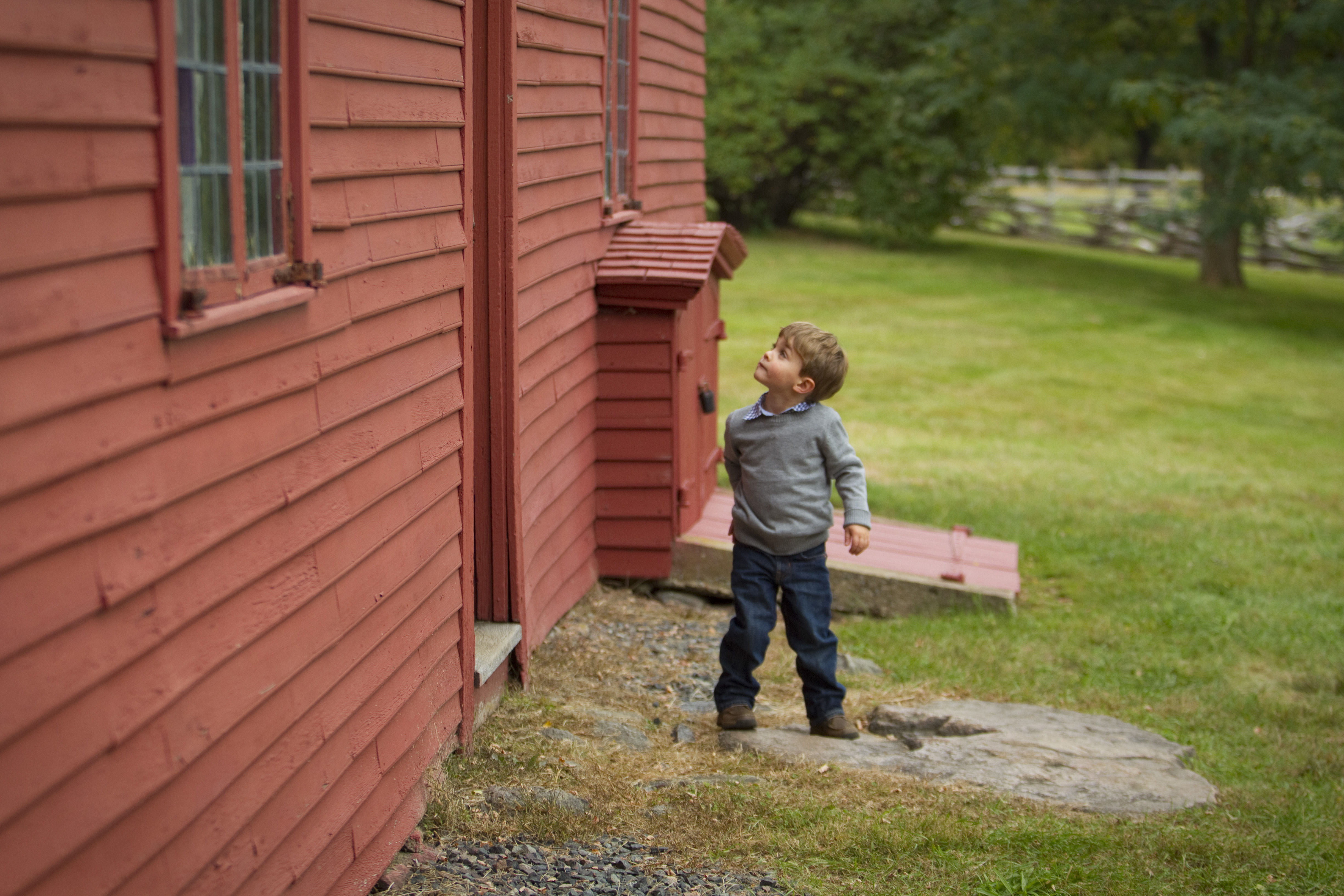 Cameron Mirabella, 3, takes a look at one of the buildings on the Rebecca Nurse Homestead.