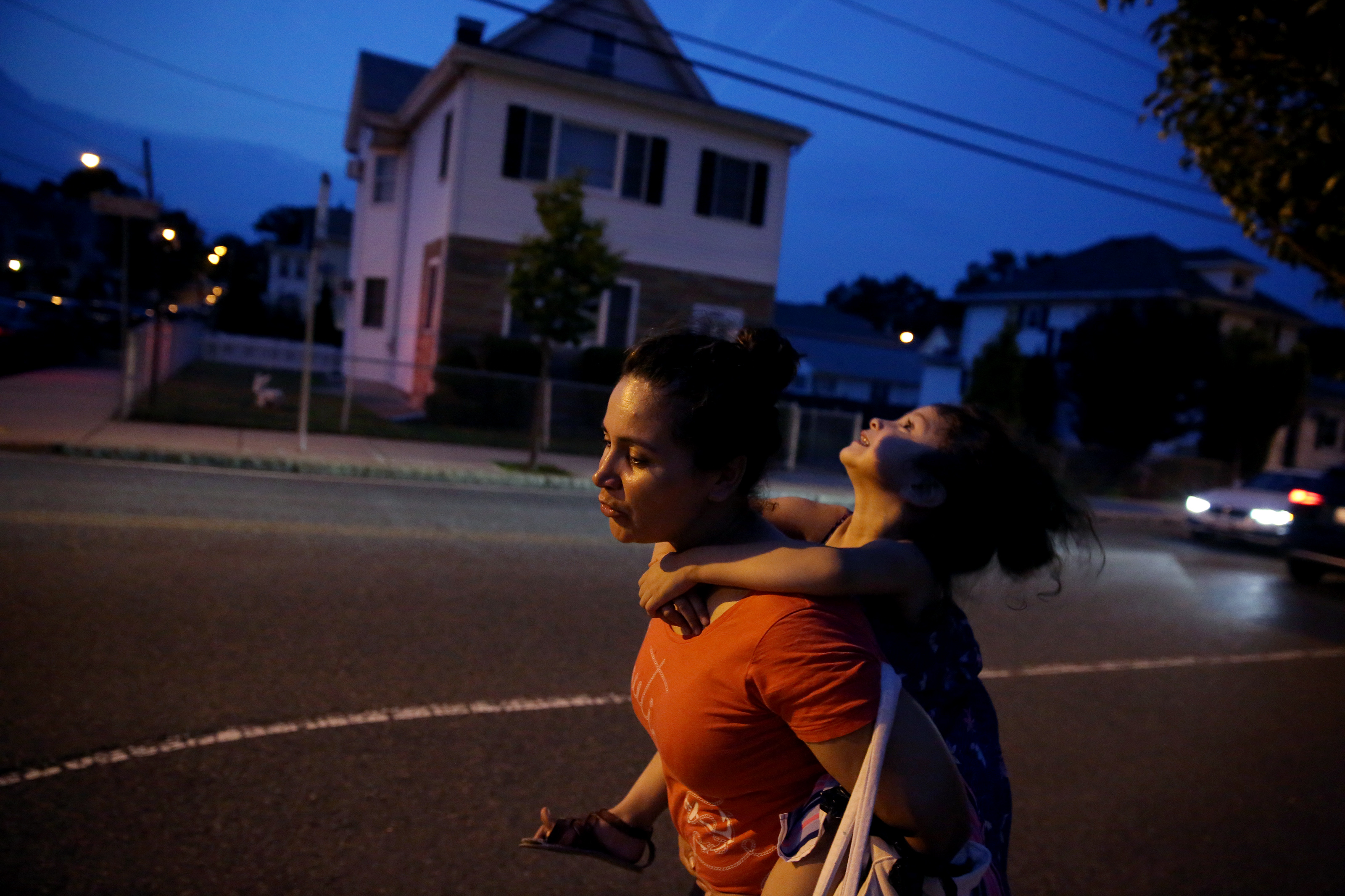As the end of the day drew near, Patricia carried Camila up the street that leads from the park back to their apartment.