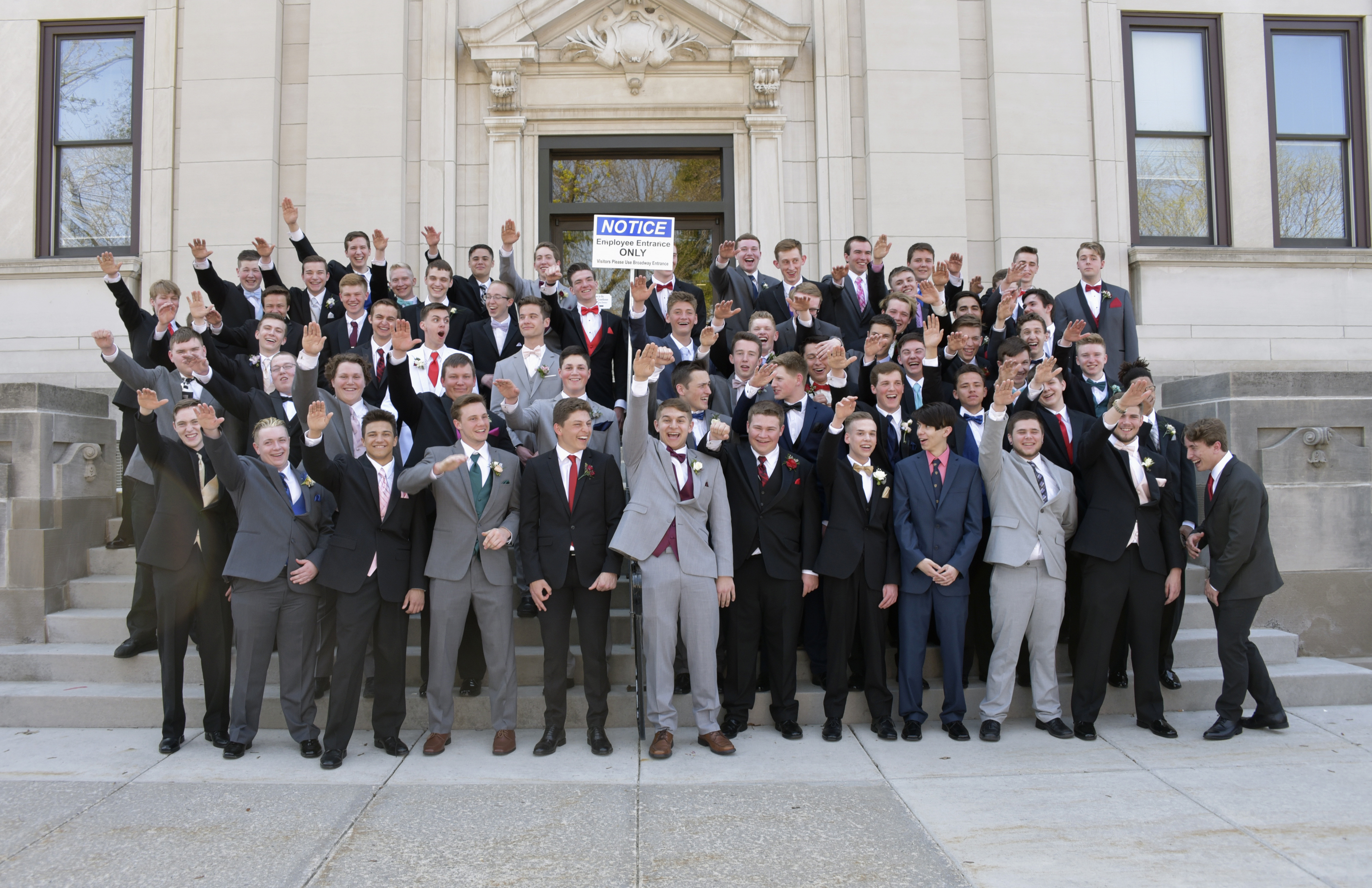 A group of Wisconsin high school boys stood on the steps outside the Sauk County Courthouse in Baraboo, Wis.