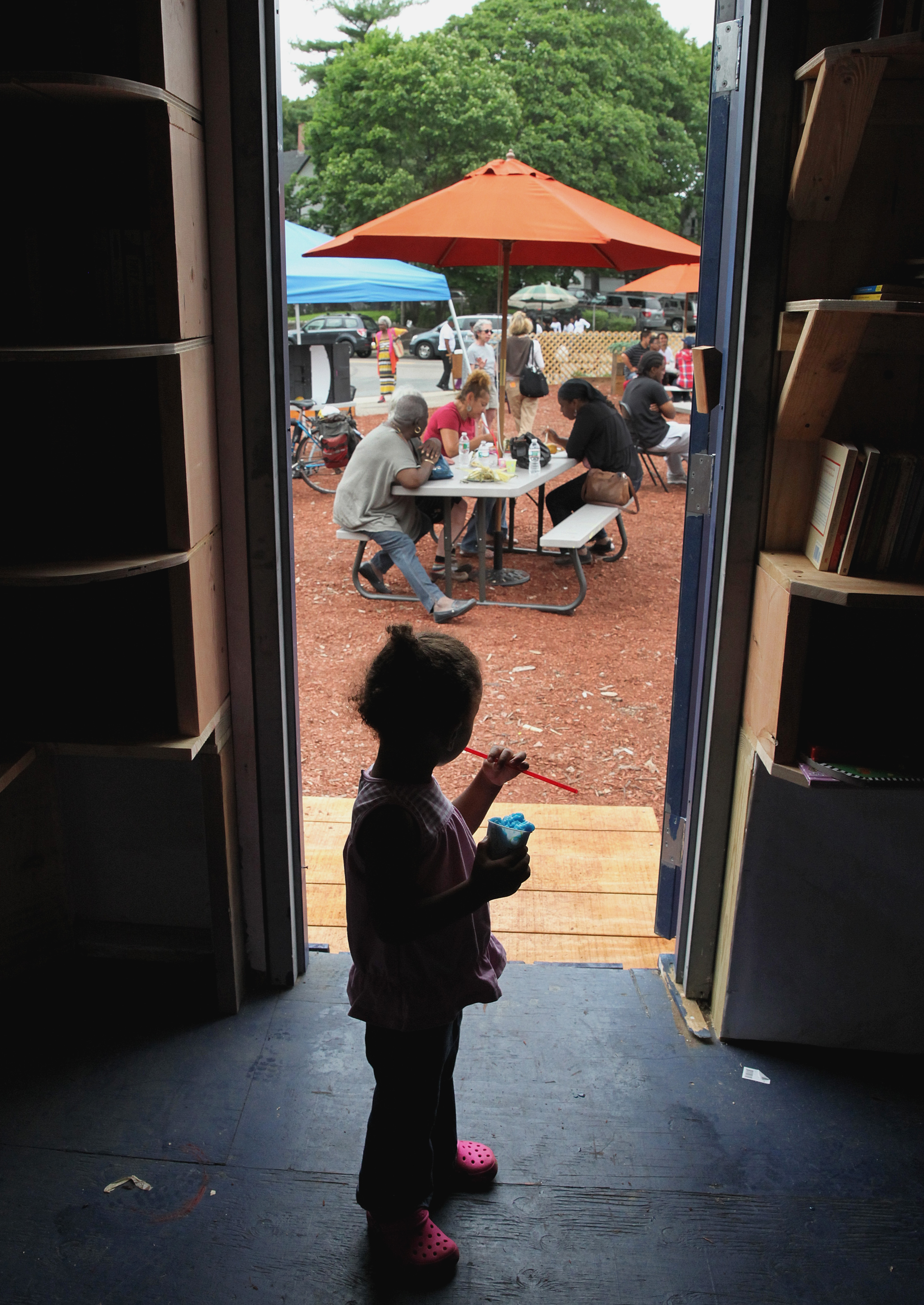 Two-year-old Aurora Kieta (left) watched the activity at the Bowdoin-Geneva Community Hub.