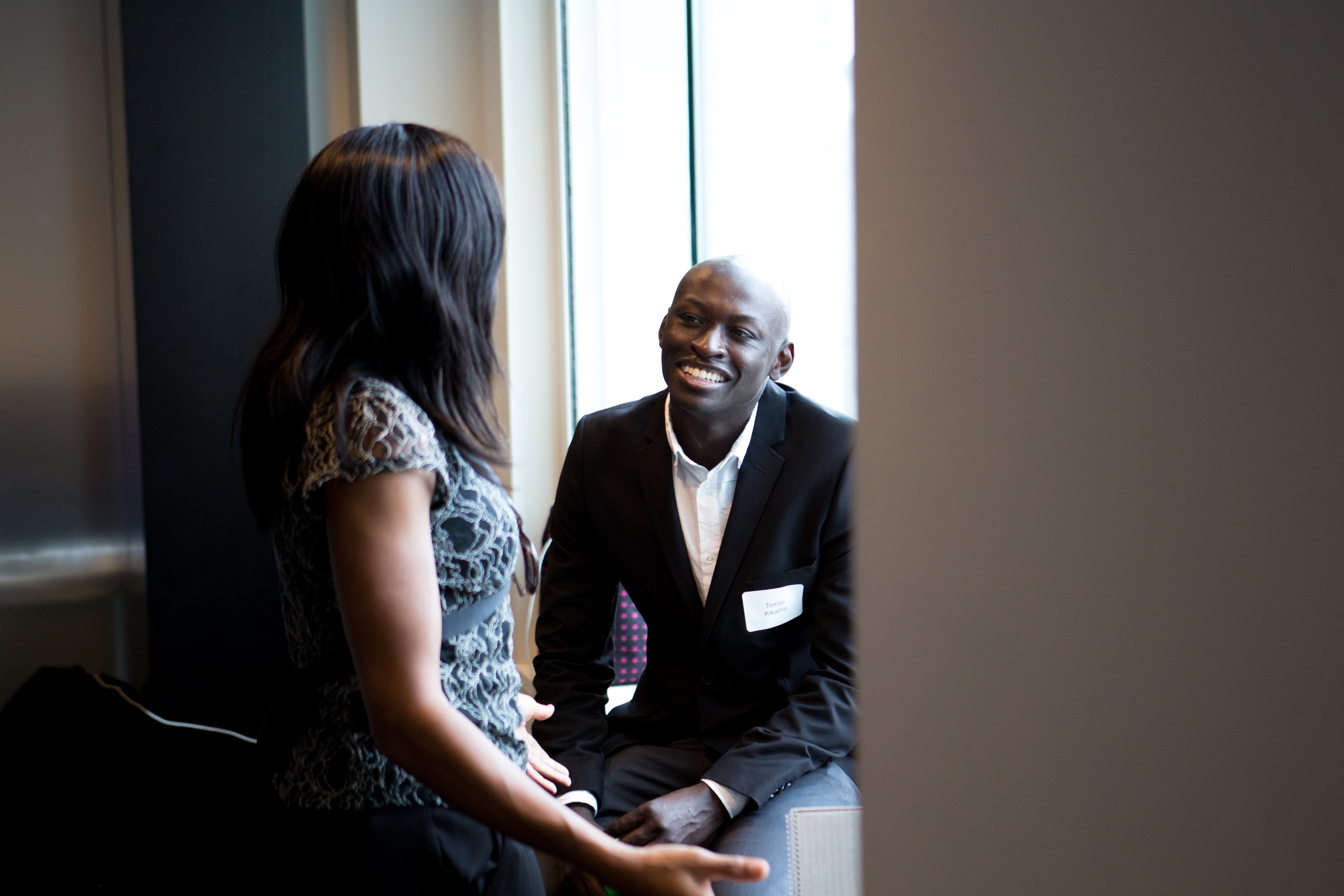 Tomisi Kikama (right) spoke with attendees of the National Black MBA Association’s fund-raiser in Boston.