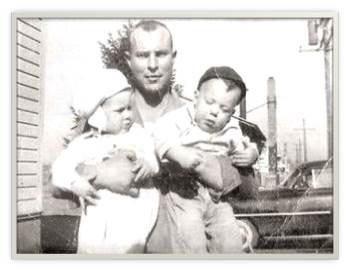 Eual Cathey holds his sons, Jeff (right) and Dan.
