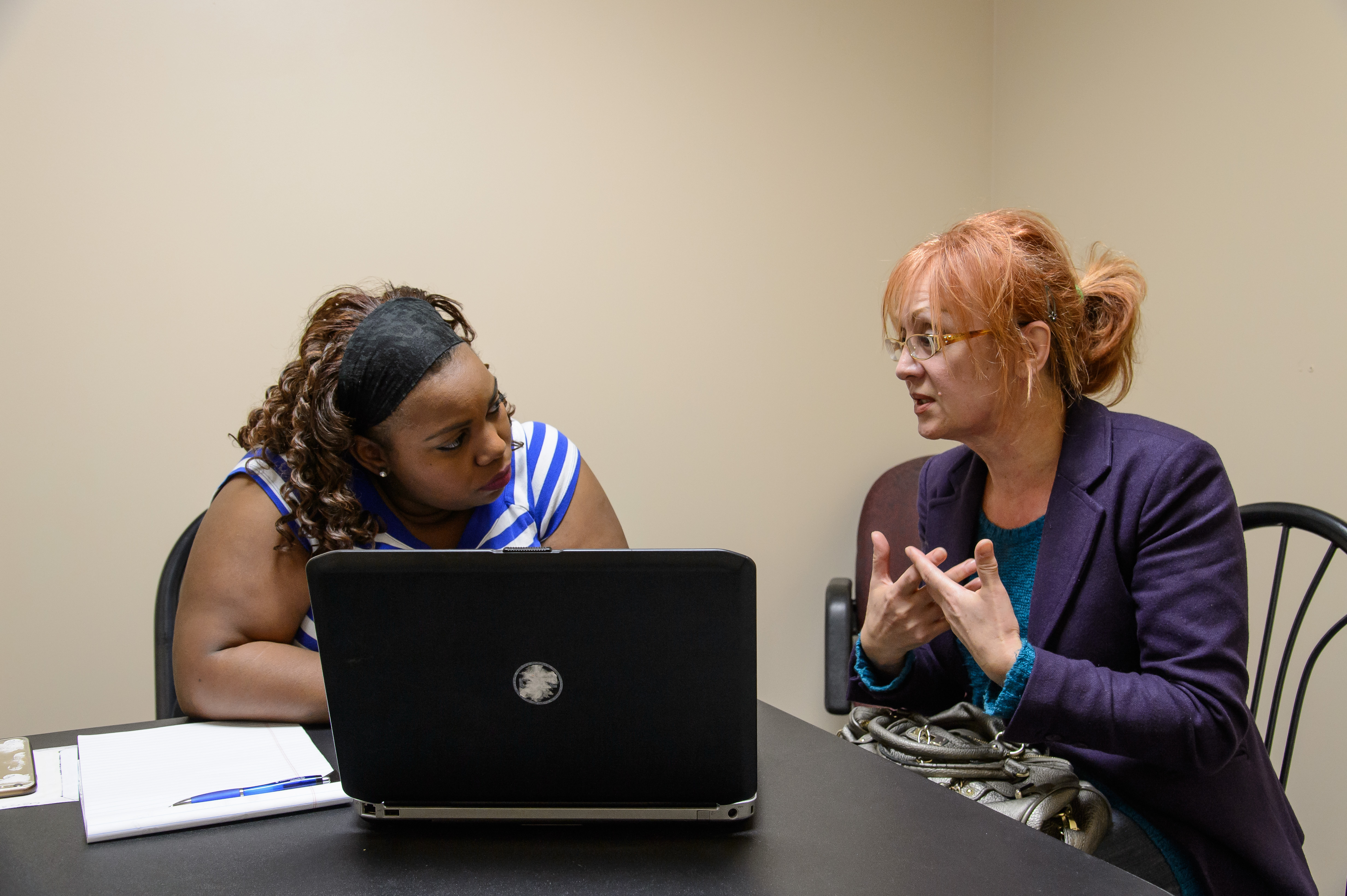 Rosa Arriola (left), an employee at a health clinic, listened as Laura Torres explained her issues with her health insurance.