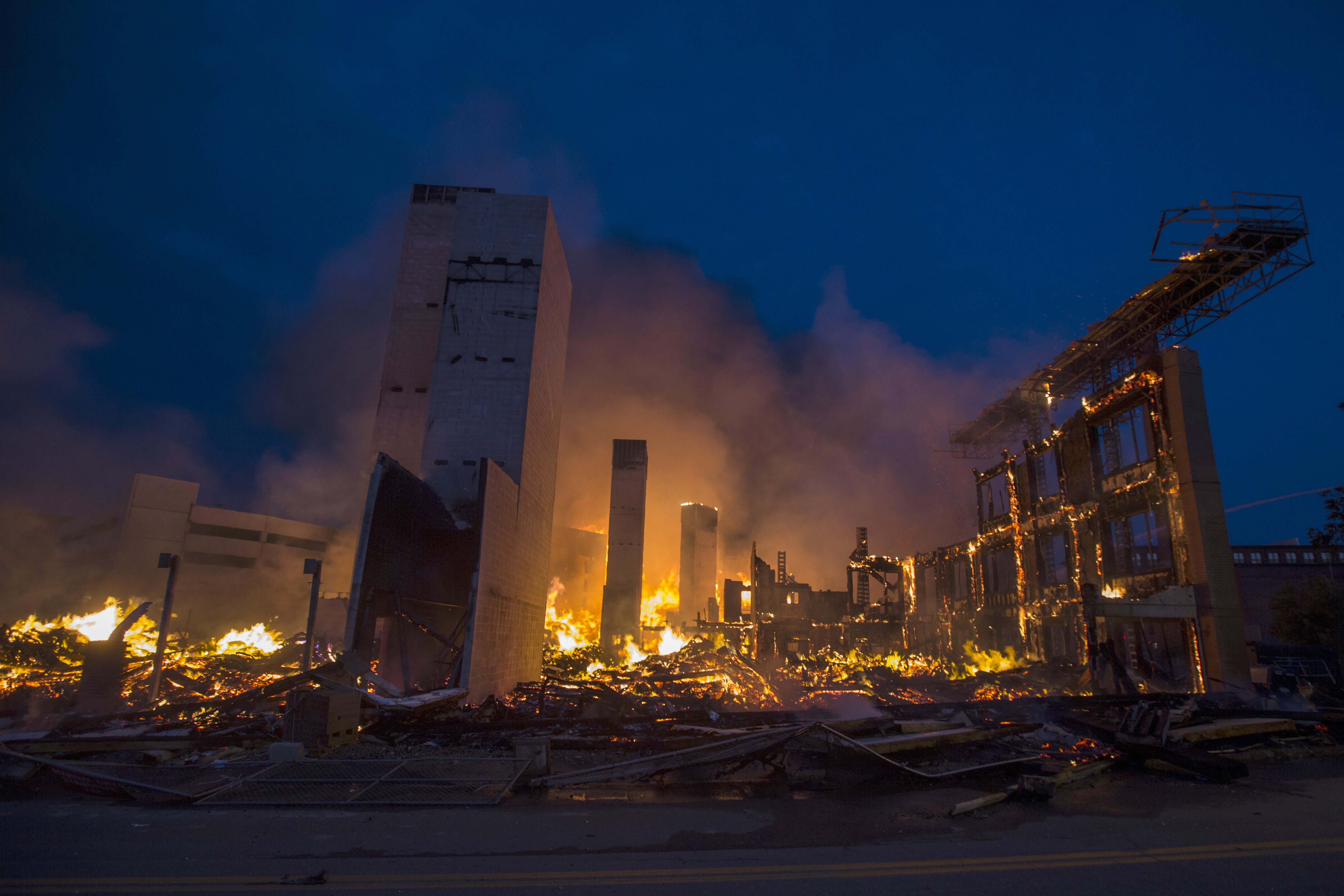 Part of a completely destroyed building burned early Sunday.