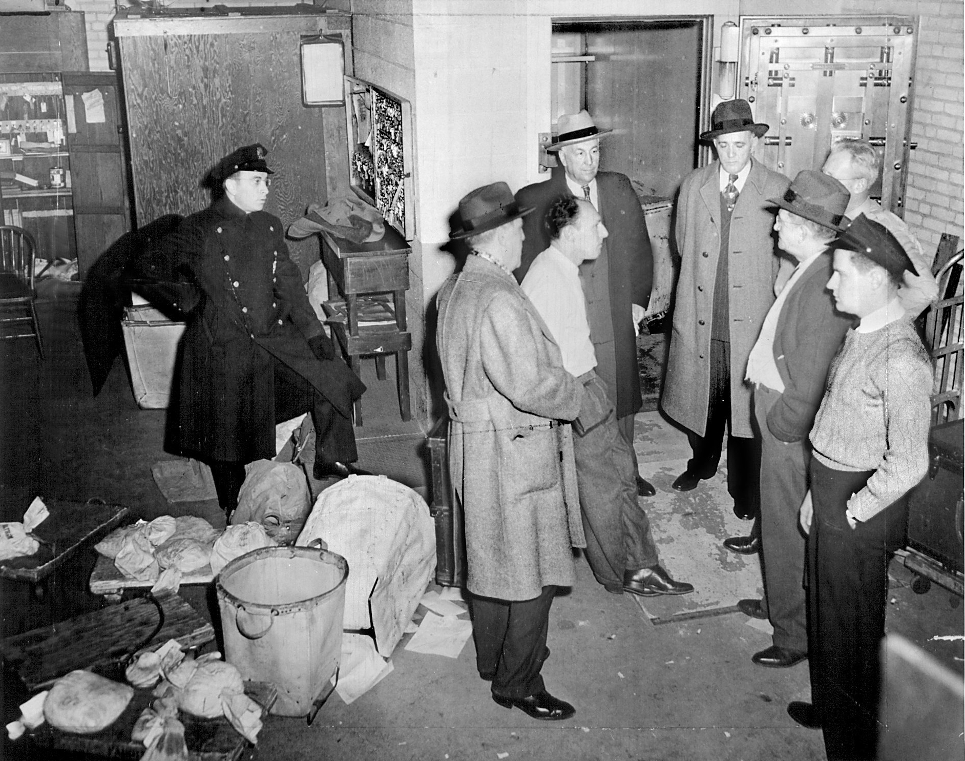 Police question Brink's employees in the vault room on the night of the robbery.
