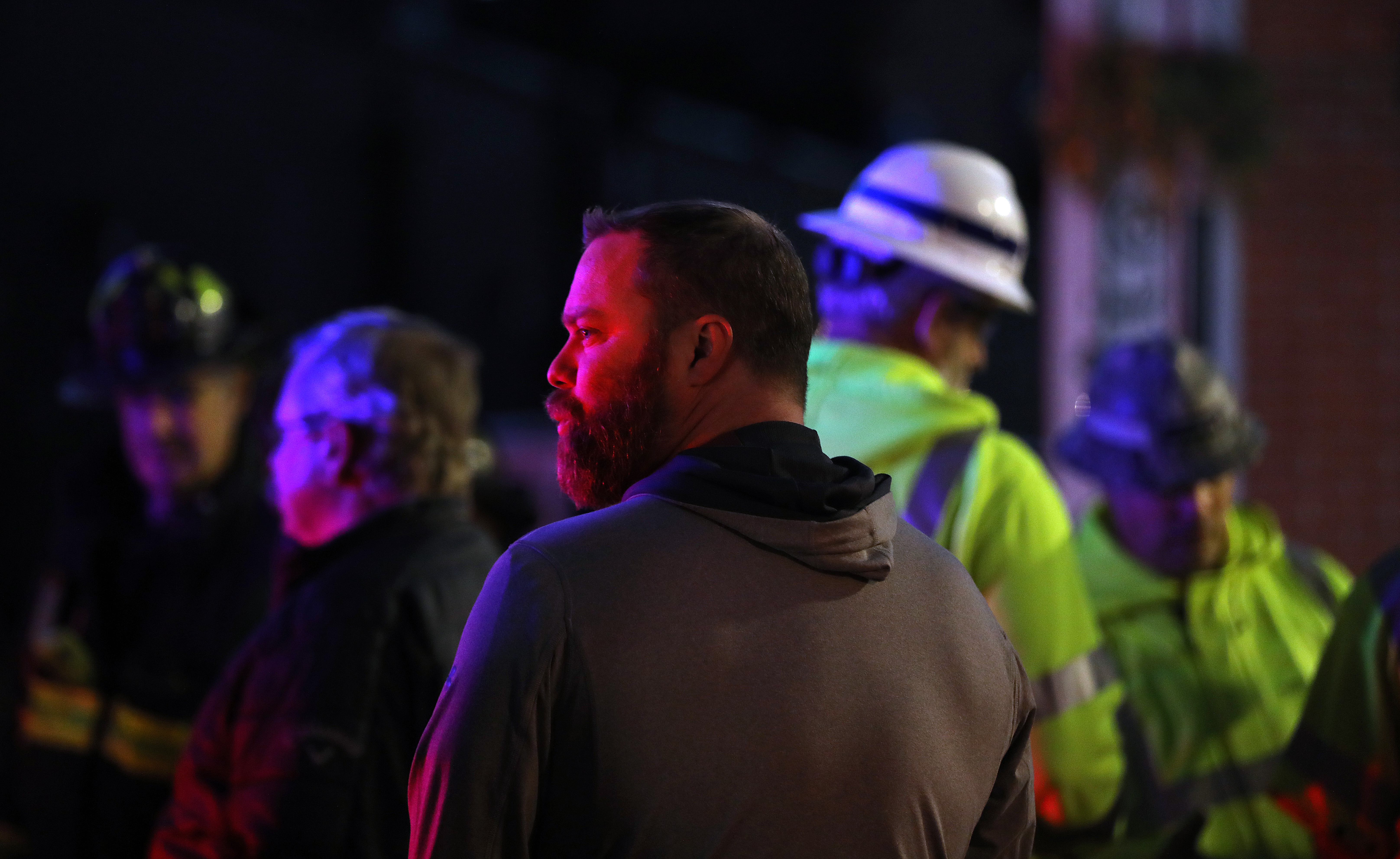 Bob O'Guin, owner of Common Ground, looked at the scene after the building facade collapsed.