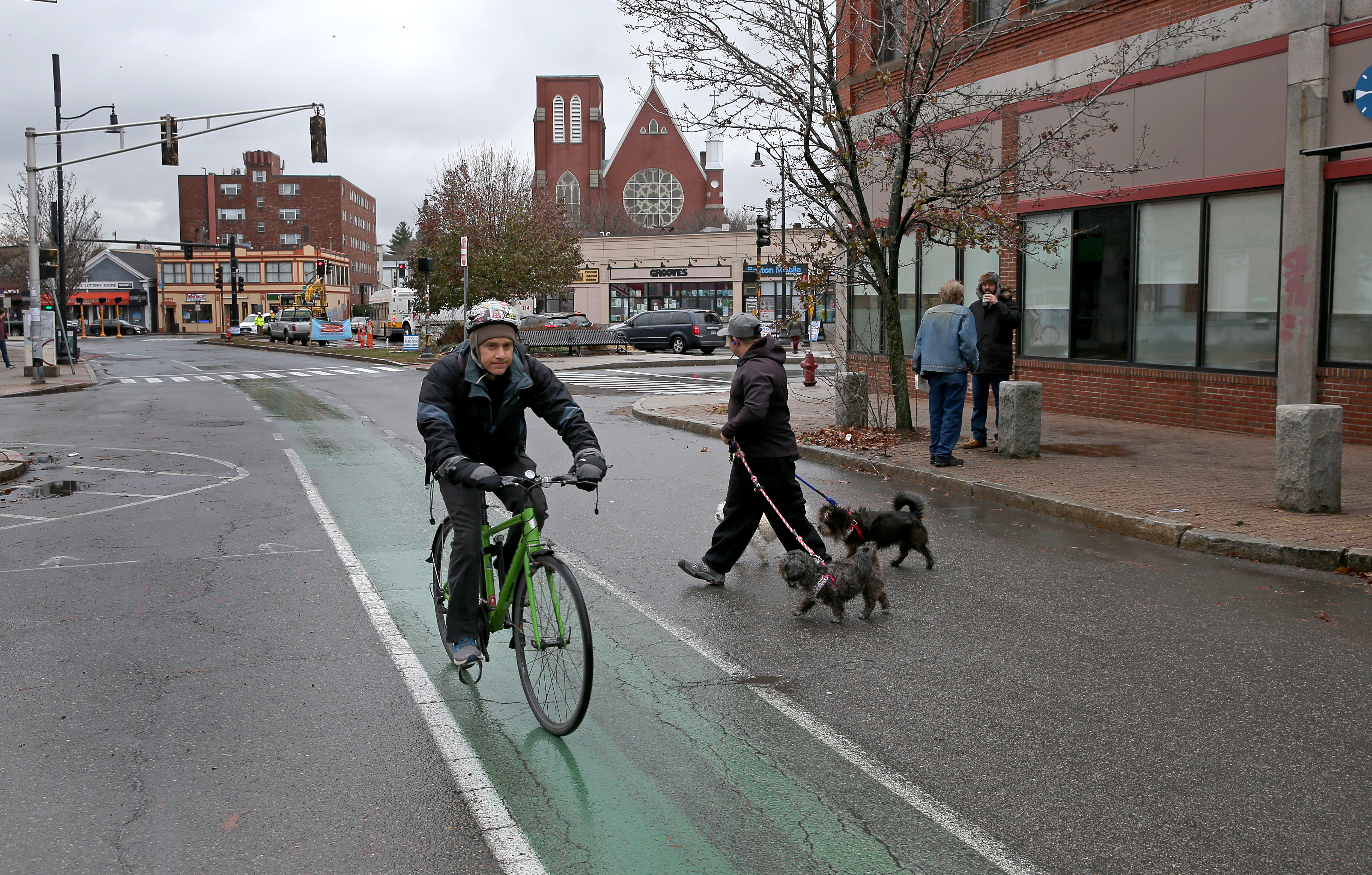 A dog walker crossed the street as a cyclists rode through Union Square.