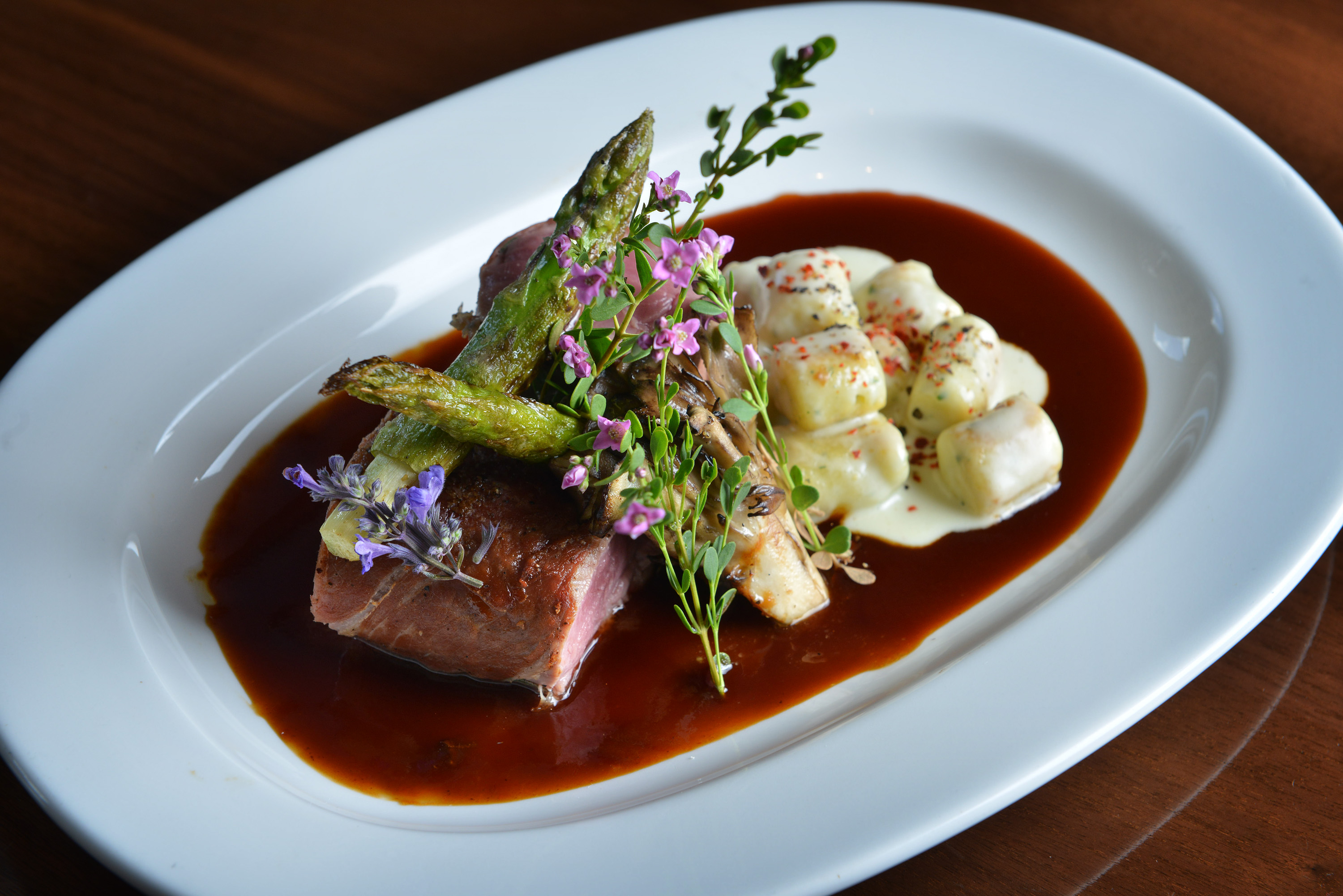 Veal tenderloin with prosciutto, maitake mushrooms, and asparagus.