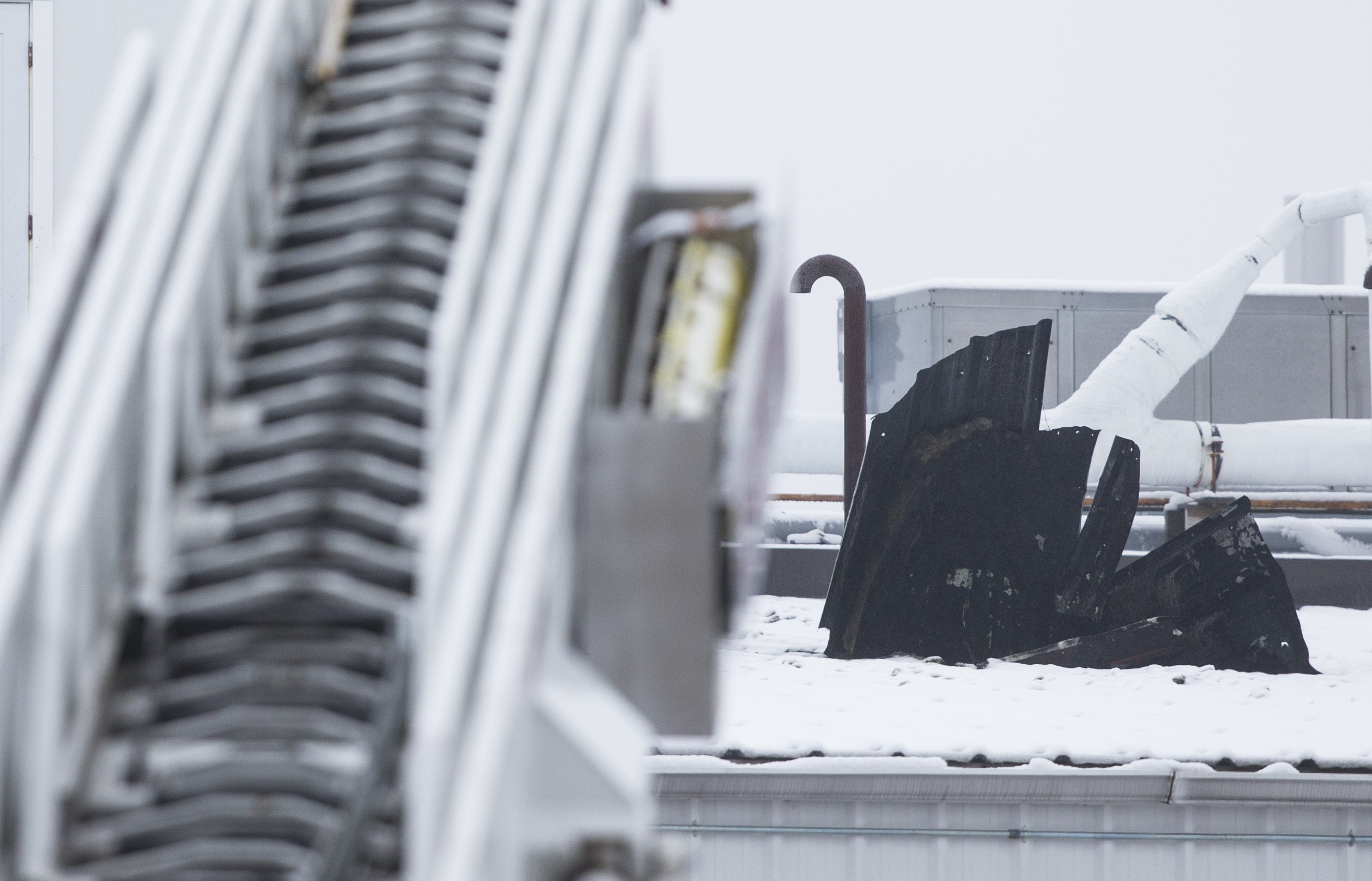 Roofing is peeled back above PCI Synthesis.