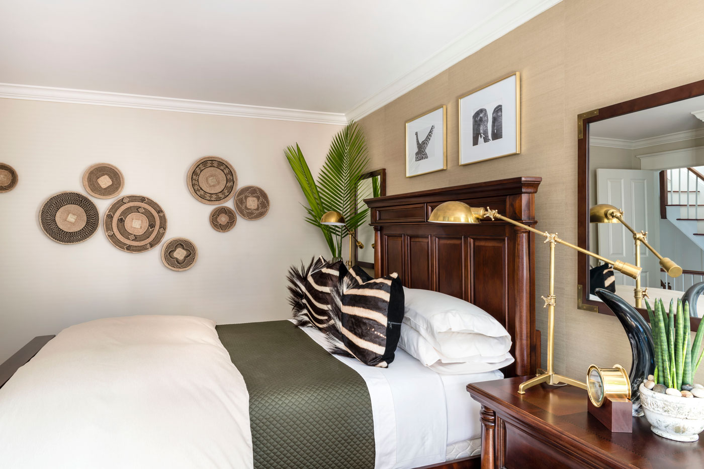 Fulmer arranged hand-woven Binga baskets from Etsy on the wall in the safari-themed guest bedroom, where the couple reused furniture Mattus owned before they met.