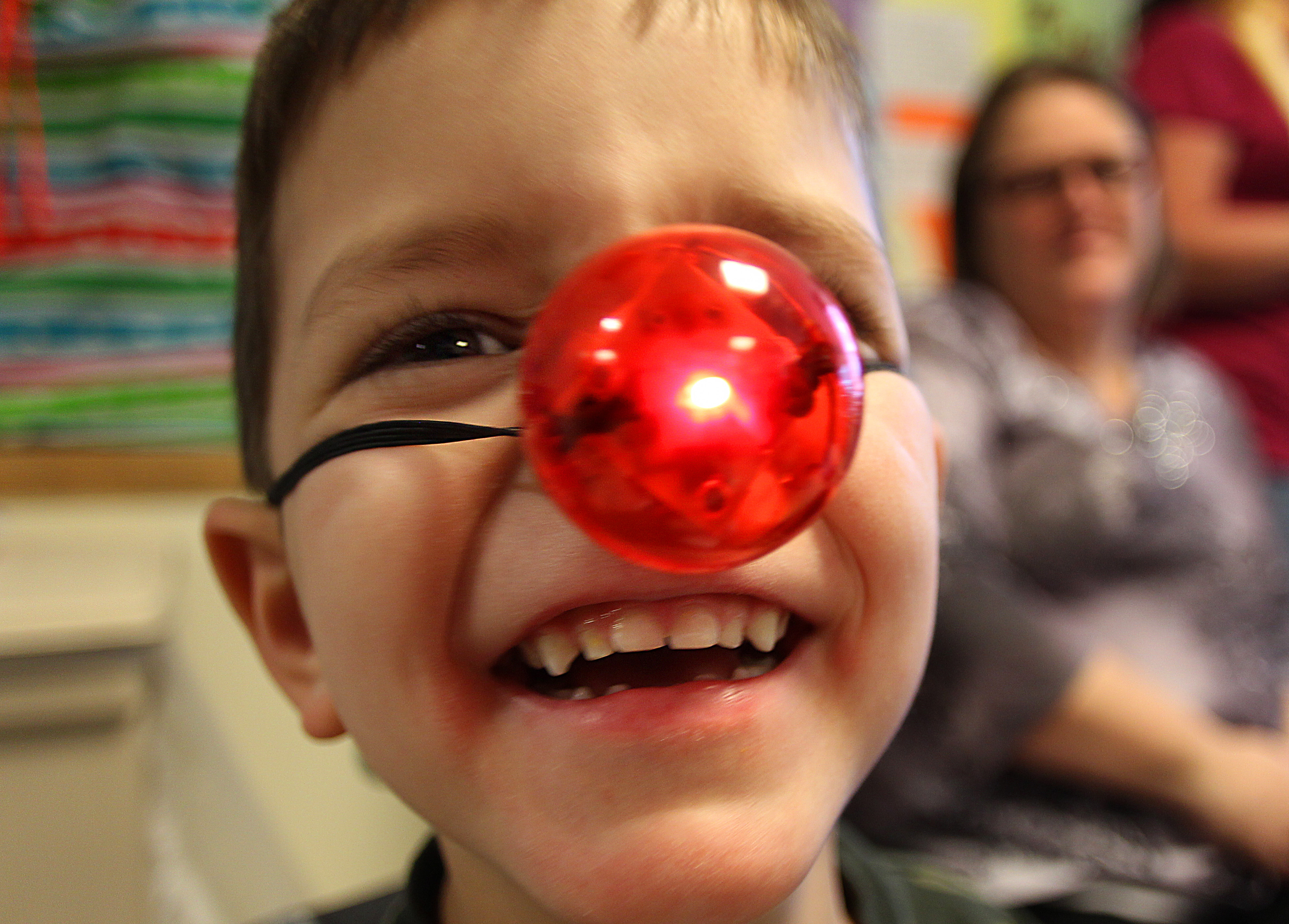 Nathan Cariker, 6, of Attleboro was delighted by a Rudolph reindeer nose given to him by andrew Ference as members of the Boston Bruins visited with pediatric patients at the Spaulding Rehabilitation Hospital in Boston.