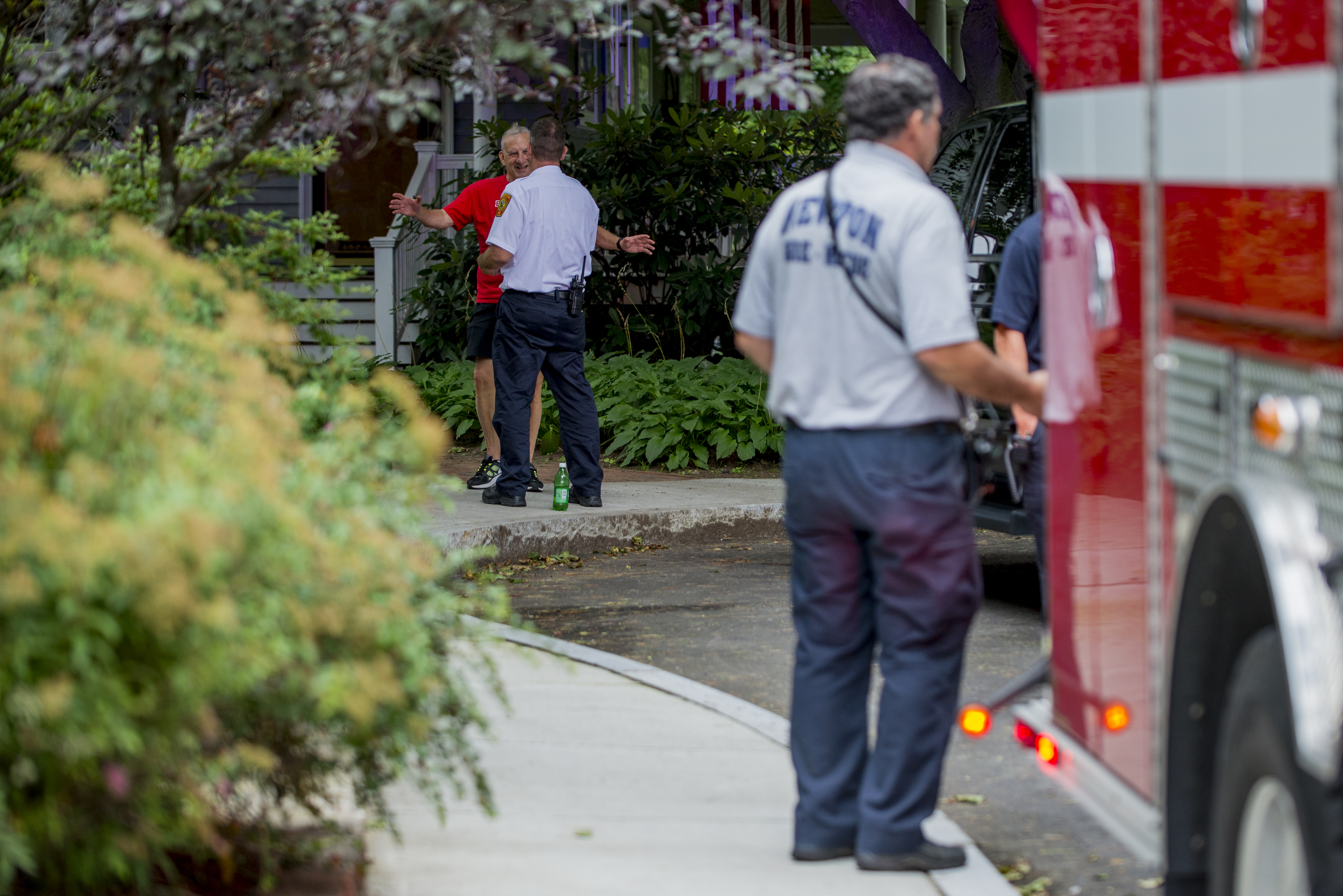 Roger Lehrberg, in red, talked with Deputy Chief of Fire Prevention Michael McNamara at the Lehrbergs’ home.
