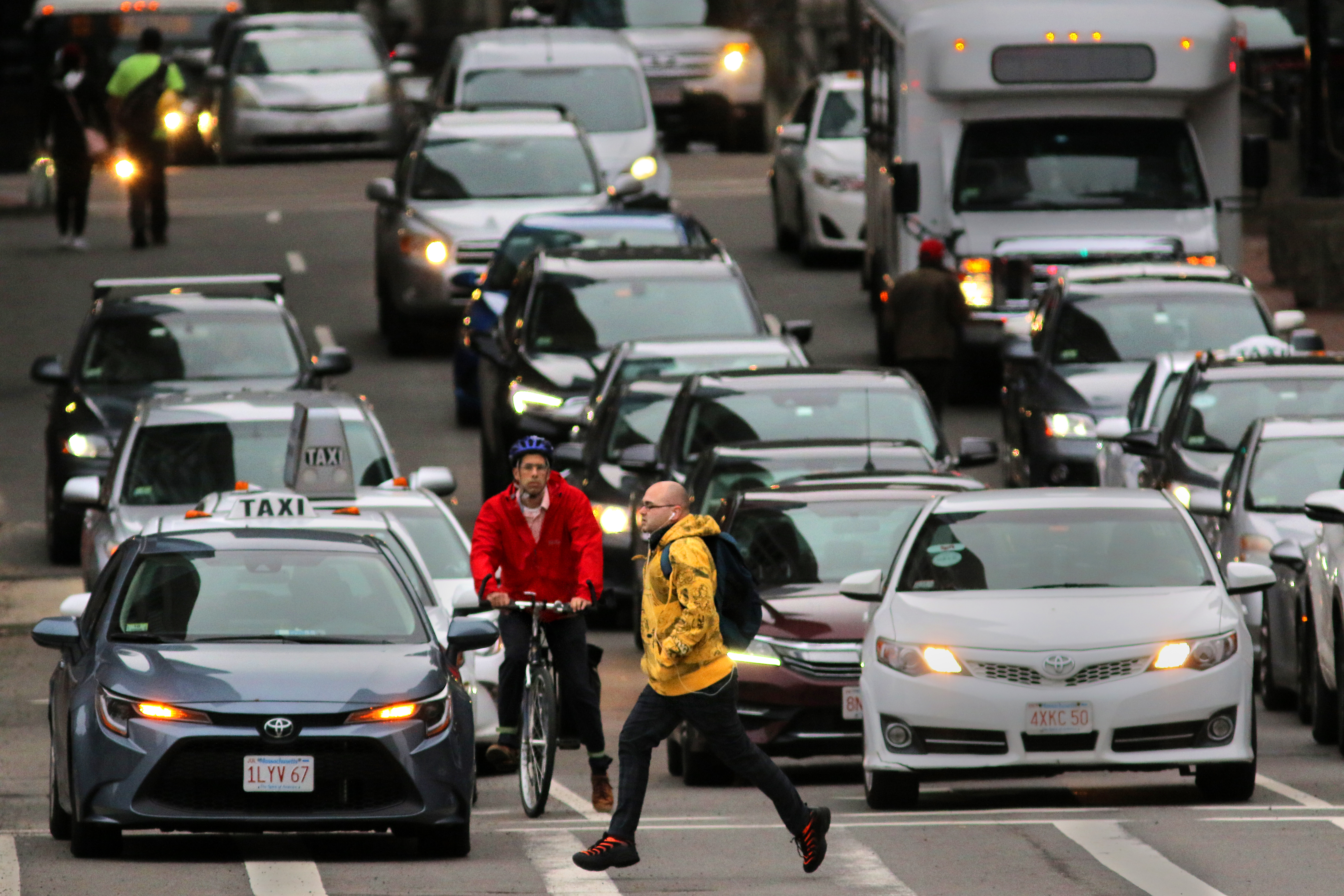 A man sprints across Congress Street near Government Center before the light changes for traffic on the evening commute.
