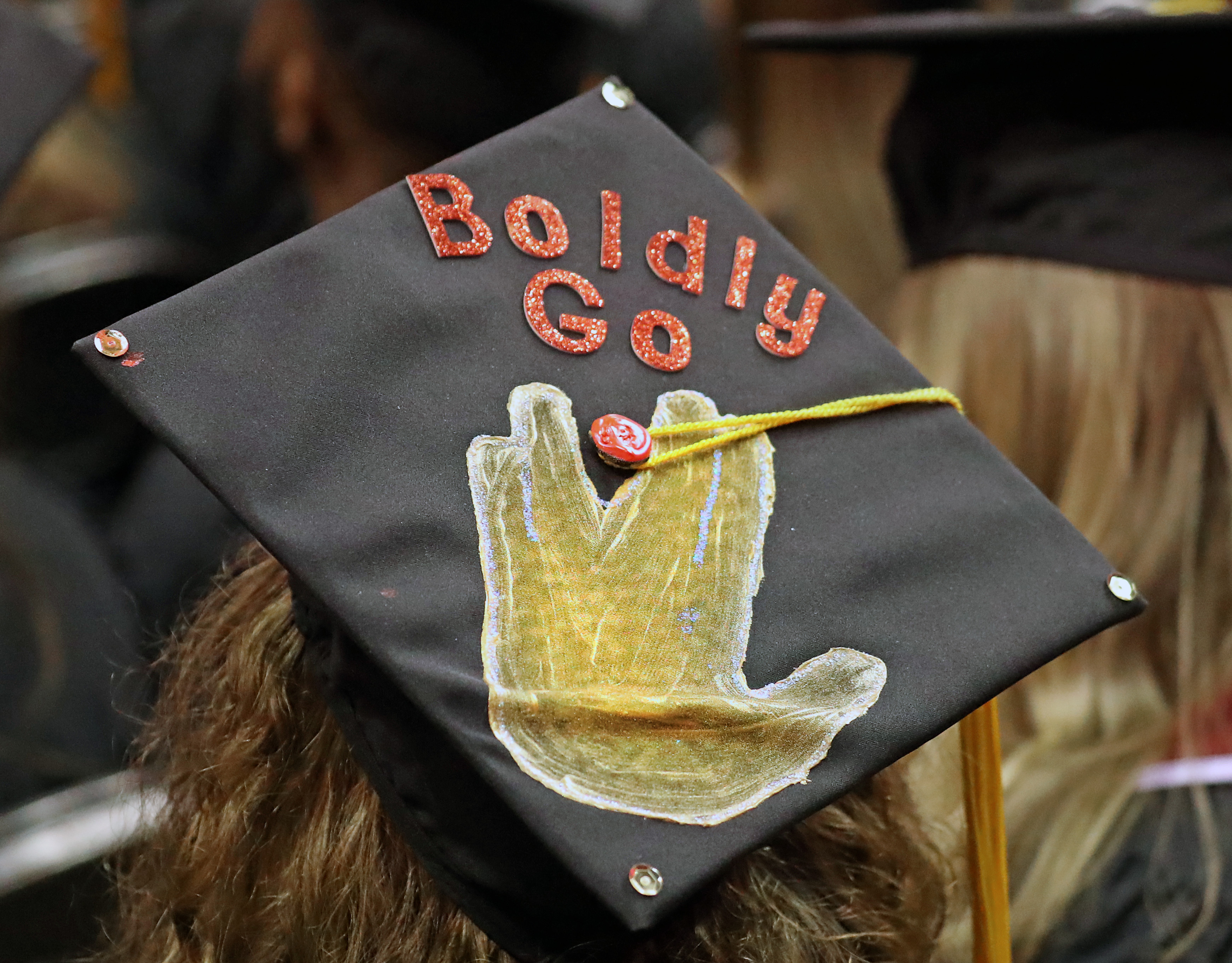 Northeastern Univerisity graduates had someting to say on their caps at TD Garden.