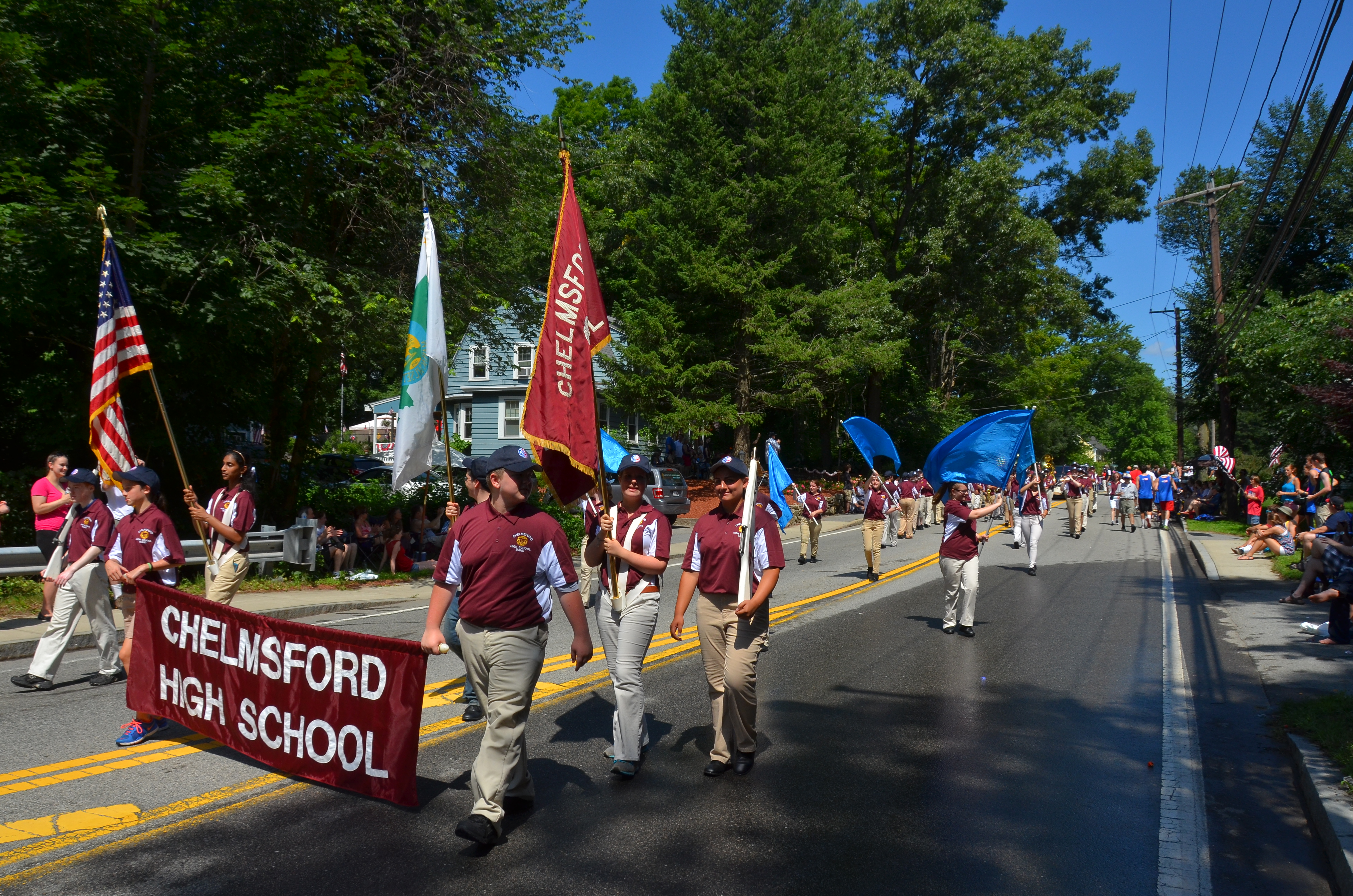 The Chelmsford High School marching band heads down North Road during a Fourth of July Parade.