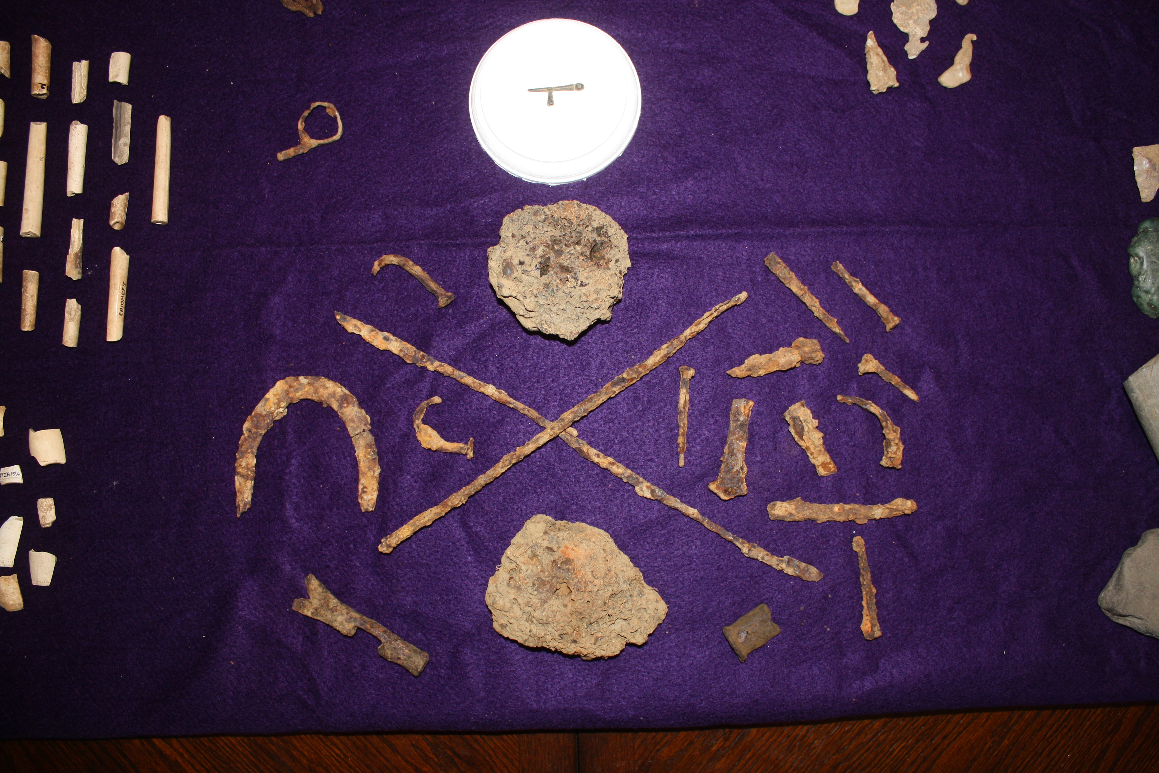 A bloomery slag, nail rods and other wrought iron items probably manufactured on site.