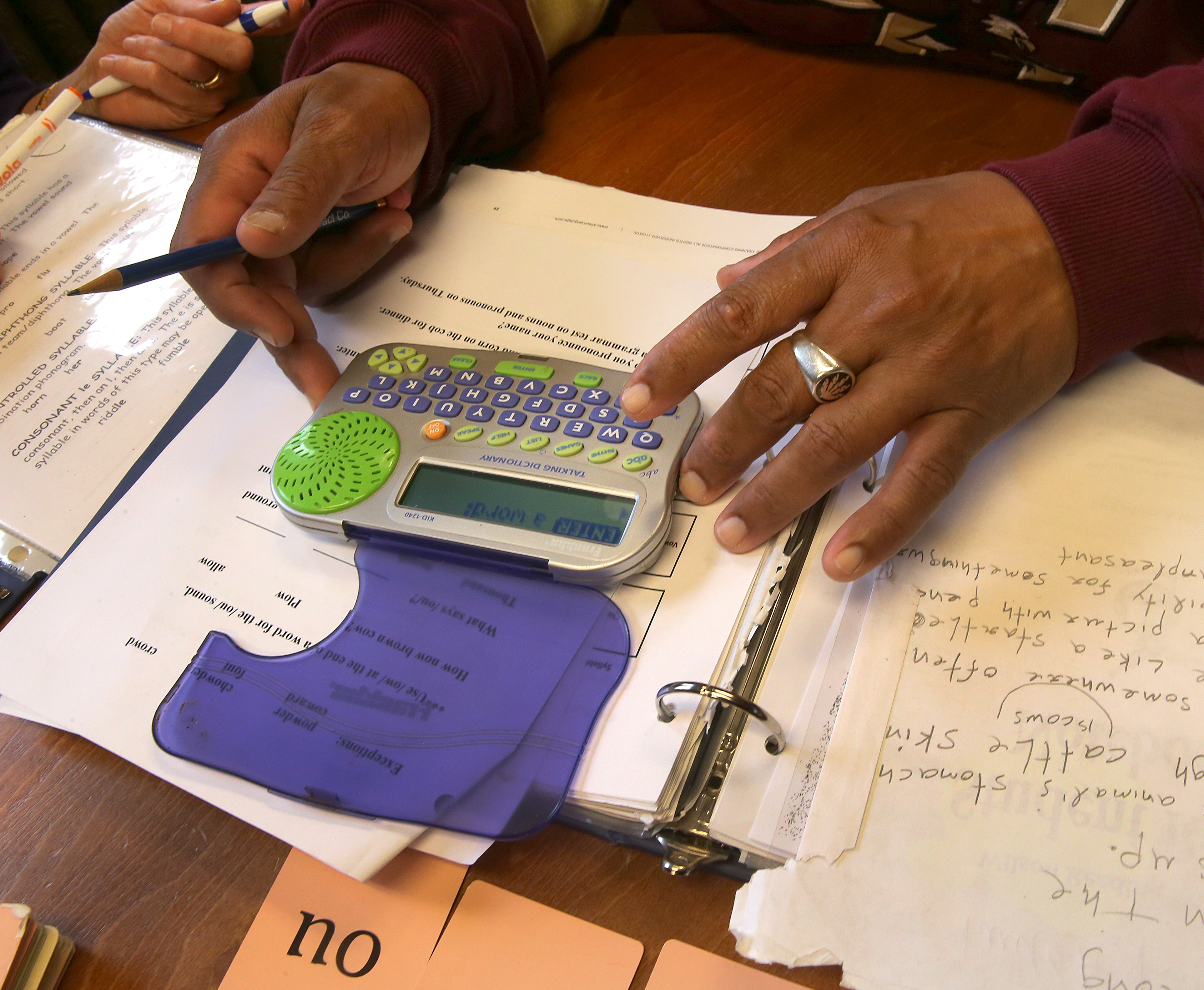 Paulo Ramos uses a small device that sounds out words as he practices his English.