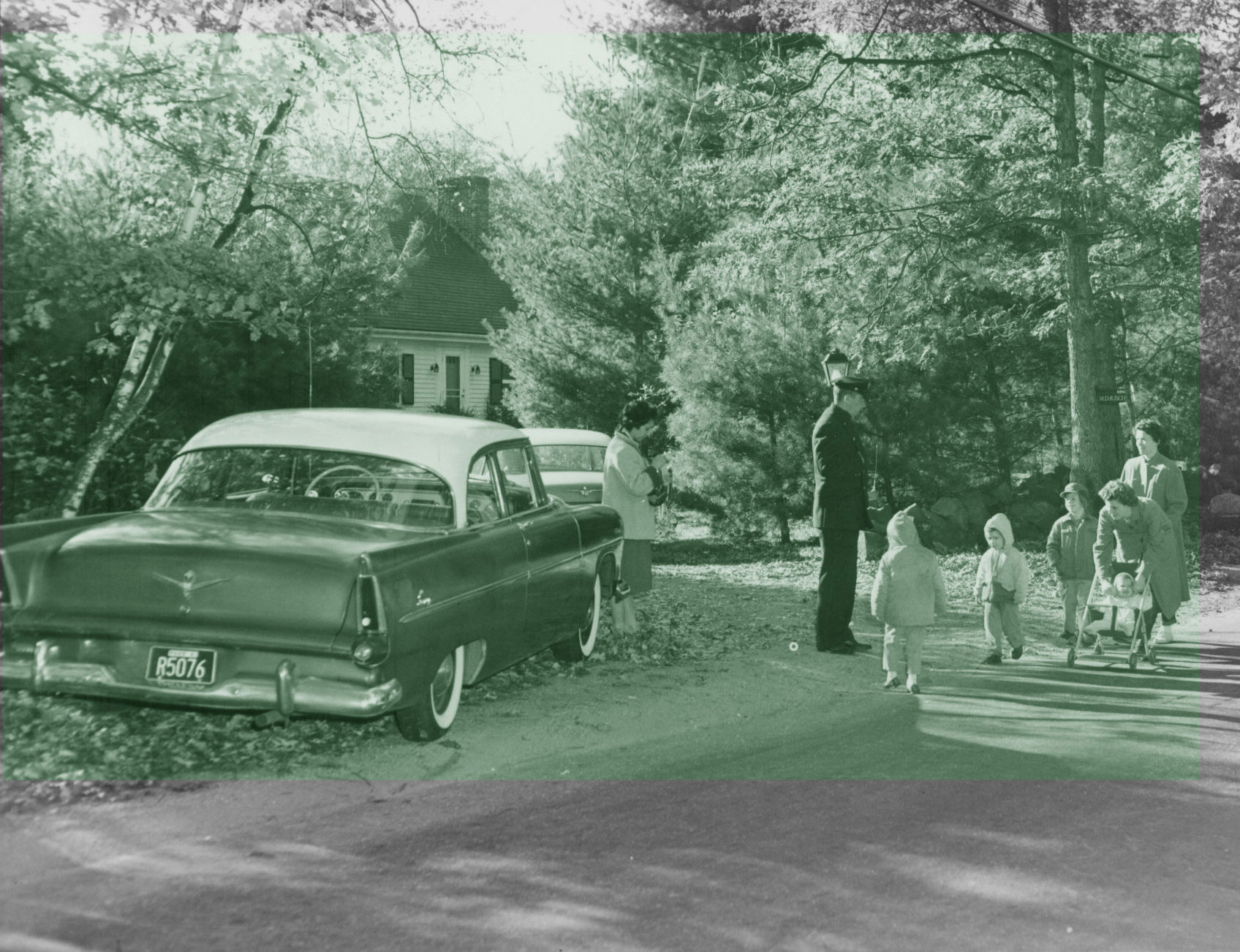 Neighbors walk by the home where Joan Risch vanished in October 1961.