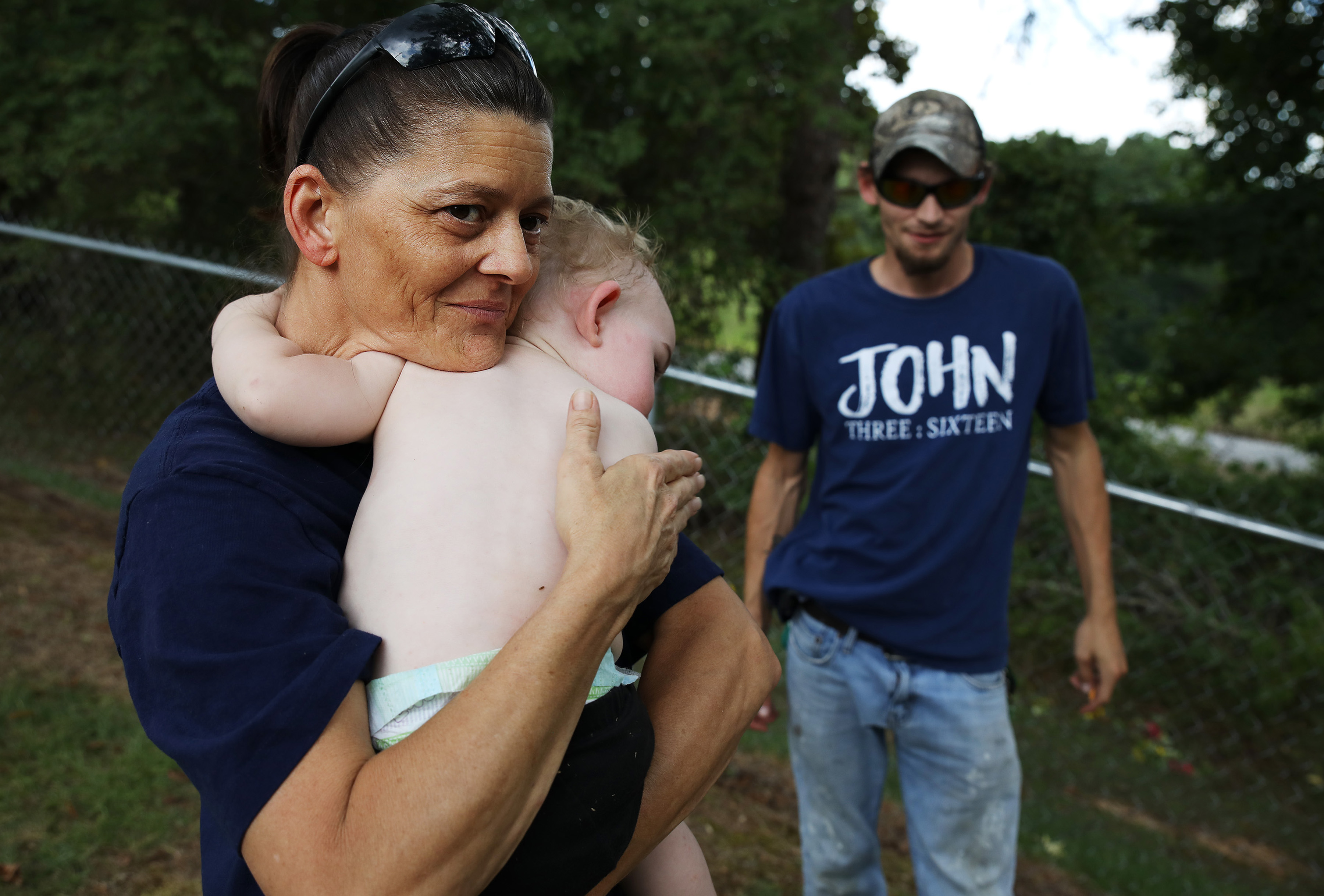 Angel Wade held her step-grandson Jason as Dylan Mann looked on. They were visiting Jasmine’s Irwin’s grave.