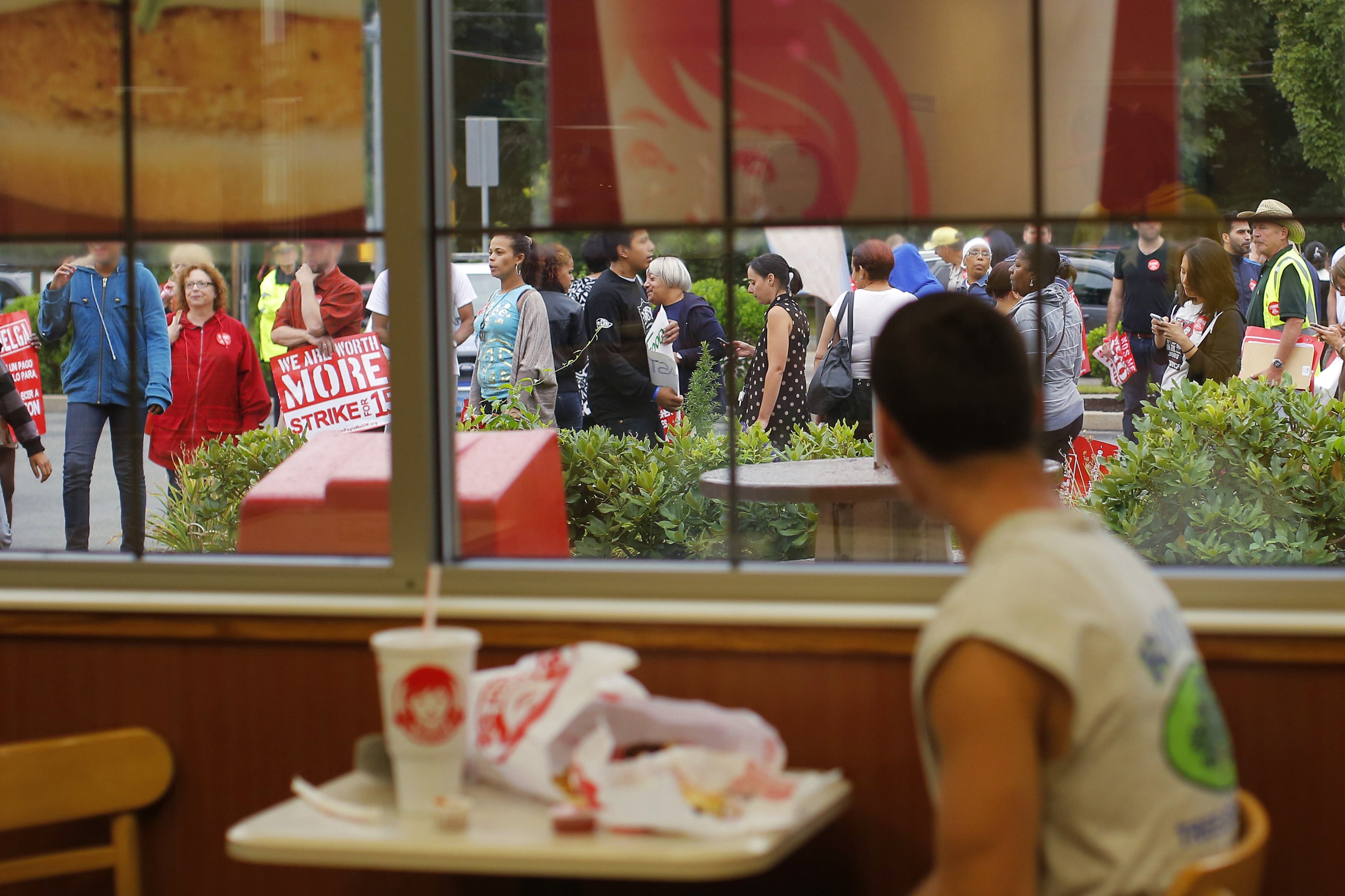 Strikers and supporters marched outside a Wendy’s restaurant in Boston Thursday.