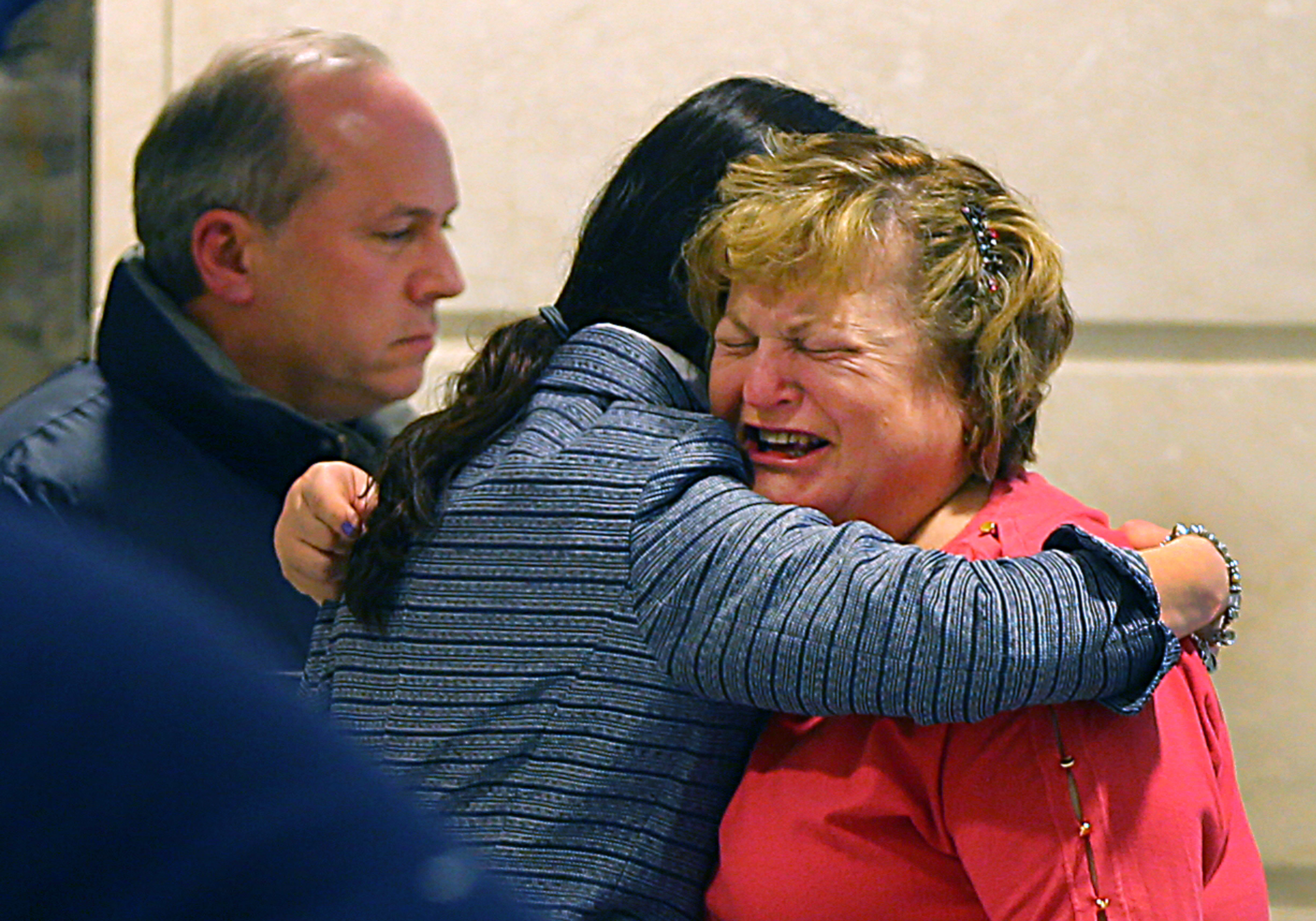 Linda Pelletier was consoled by her attorney, Christine Tennyson, after the hearing as Linda's husband, Lou, looked on.