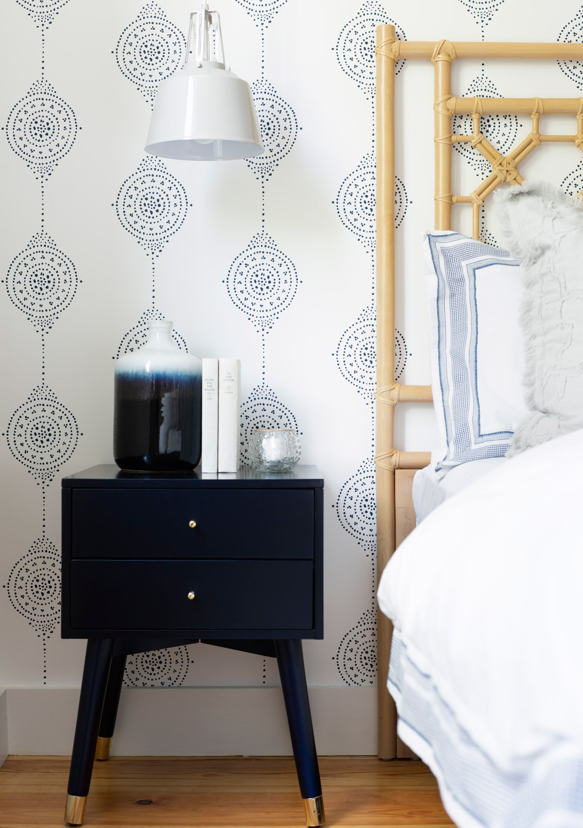 The starting points for the master bedroom were the Luna Stripe wallpaper from Serena & Lily and the rattan headboard. “I wanted it to be light and neutral, with just a little color,” Desiree Burns says.