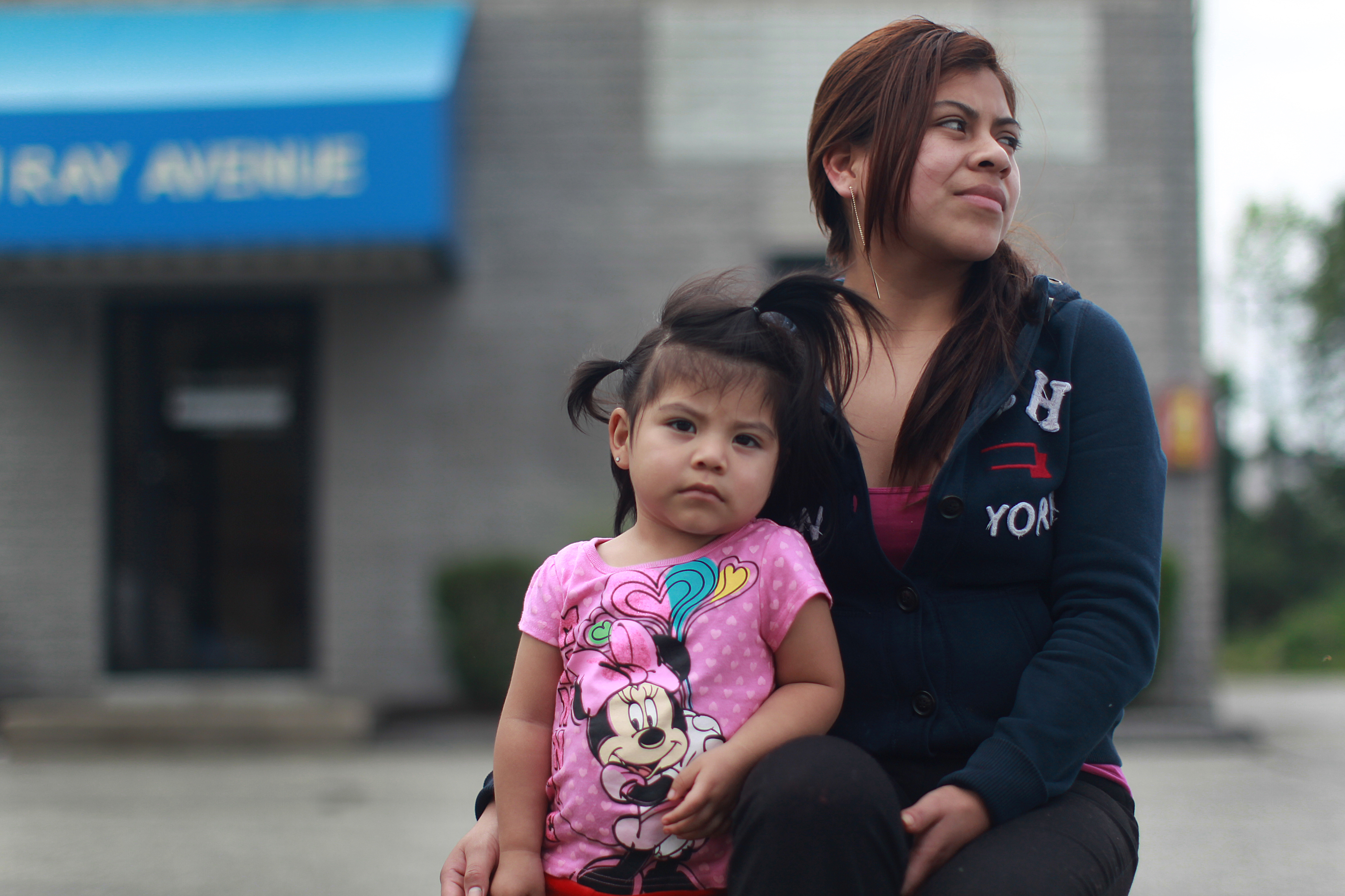 Veronica Morales, shown with her daughter, travels to Burlington from Lynn weekly to have her GPS device checked.