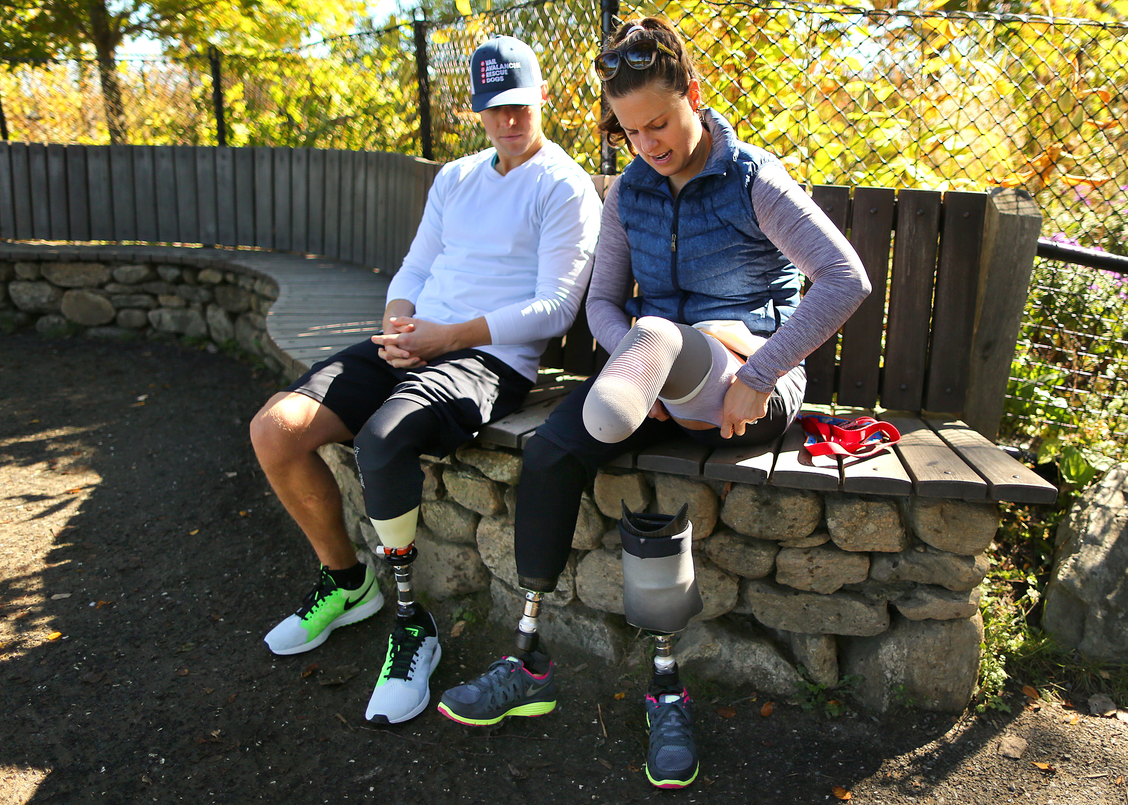Patrick Downes and Jess Kensky took a break from their walk at Fresh Pond this month as she removed her left prosthetic leg to check for signs of bursitis.