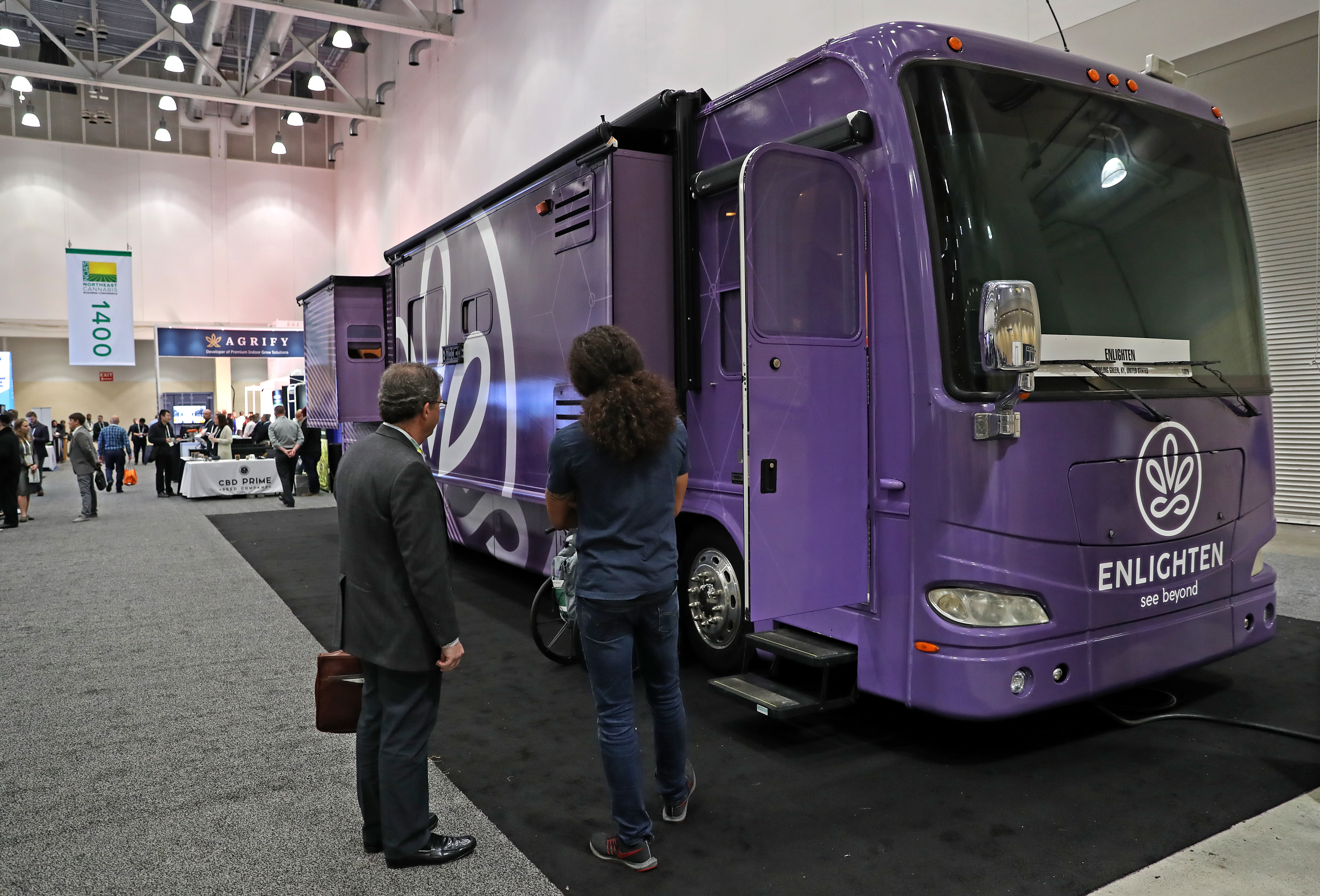Blake Norris speaks to a CannaBus visitor at the Northeast Cannabis Business Conference.