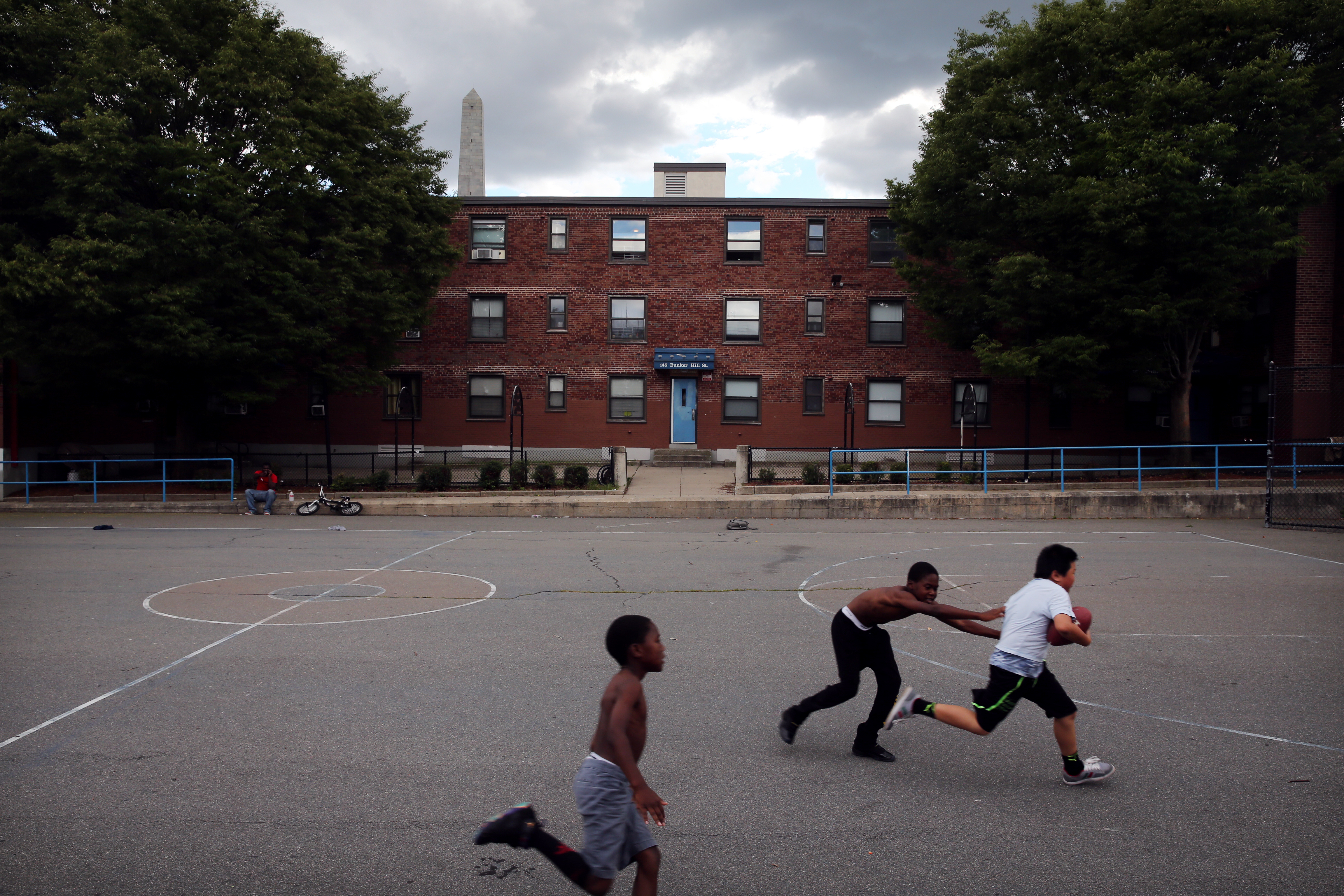 Jewelz Riley, 8, and his brother David, 10, played football in Bunker Hill with Evan Yang, 10.