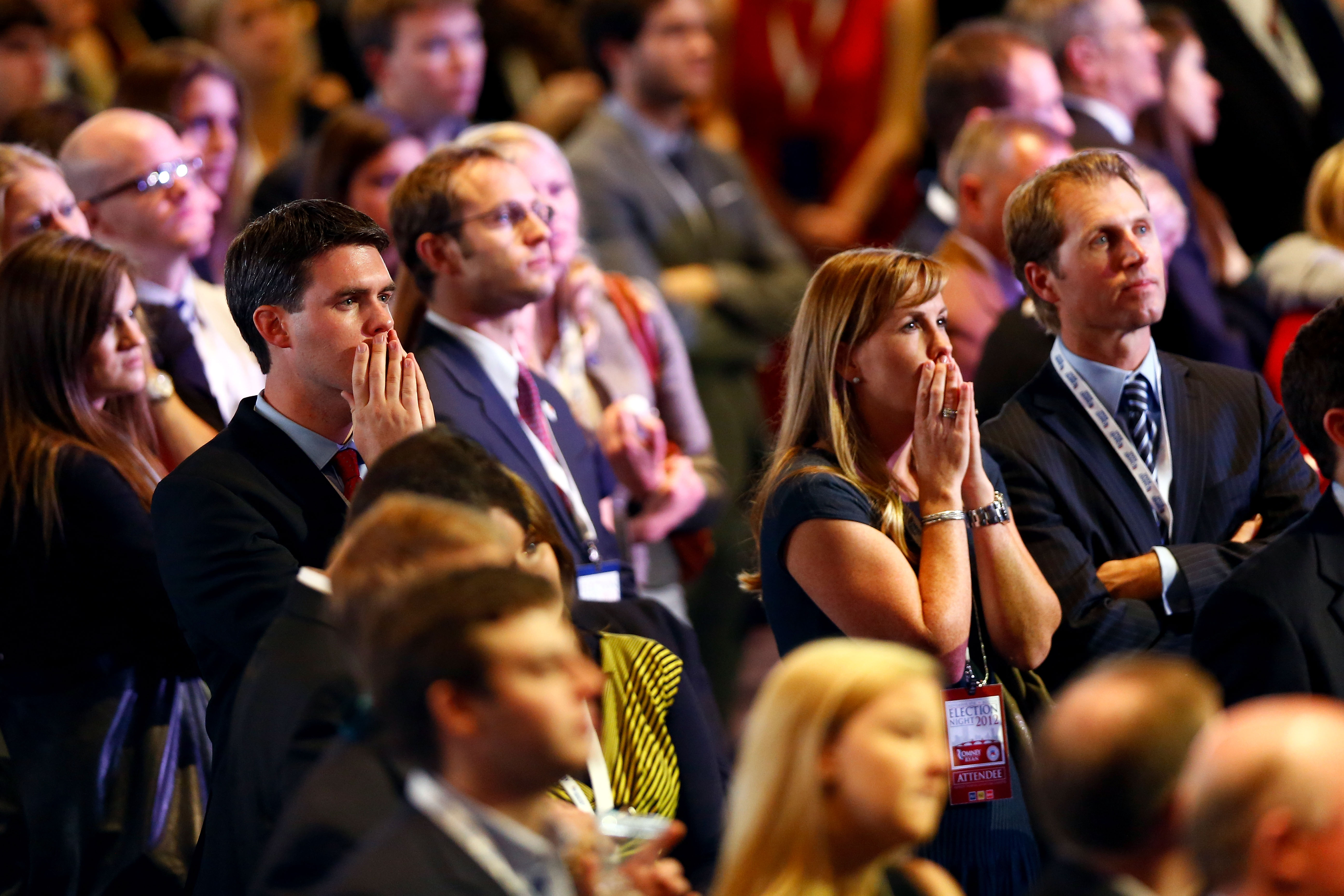 Spectators react to election results displayed on large screens at the Romney campaign’s election night headquarters, at the Boston Convention & Exhibition Center/Matthew Cavanaugh/Getty Images