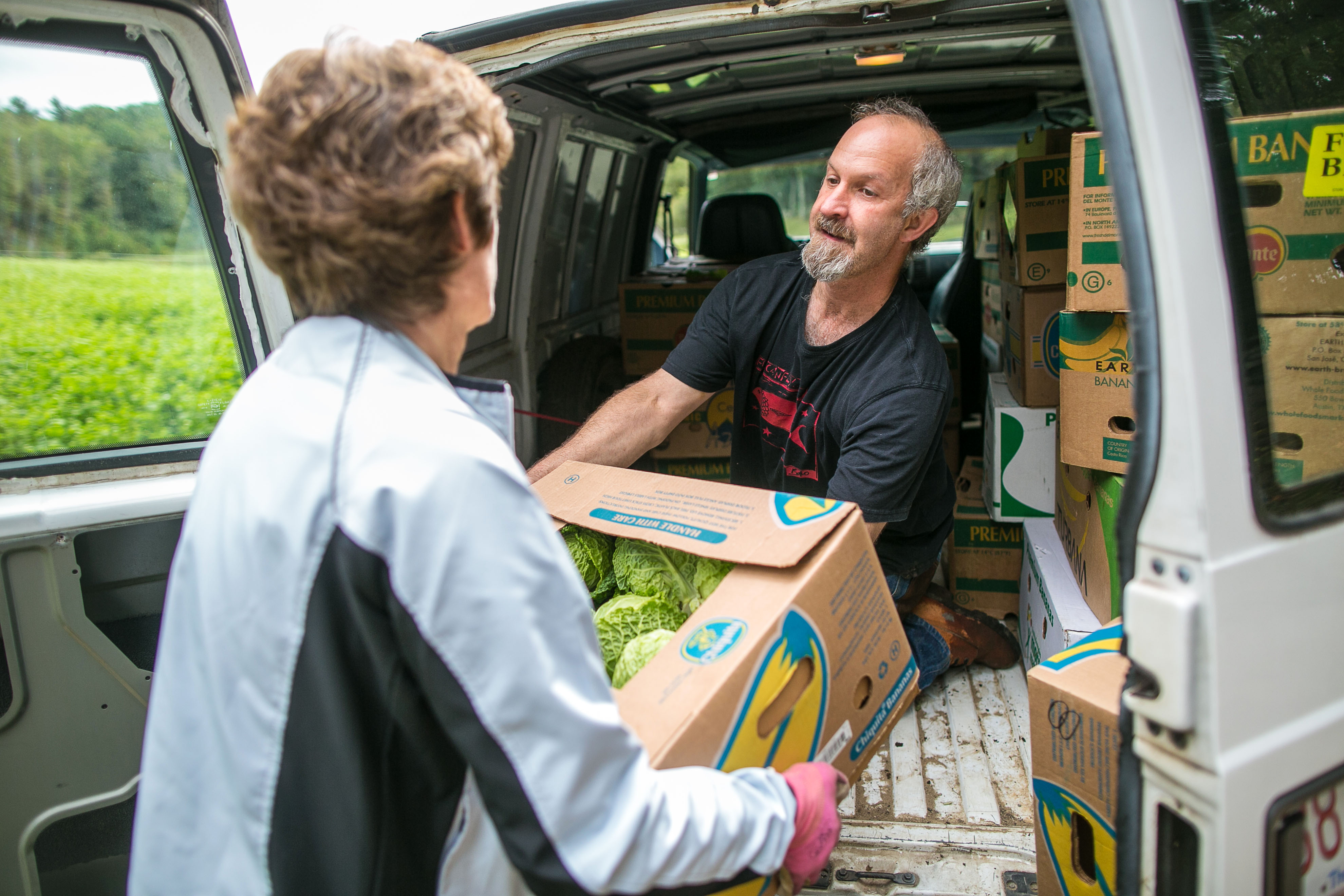 Lynn Langton and Todd Kaplan load cabbages.