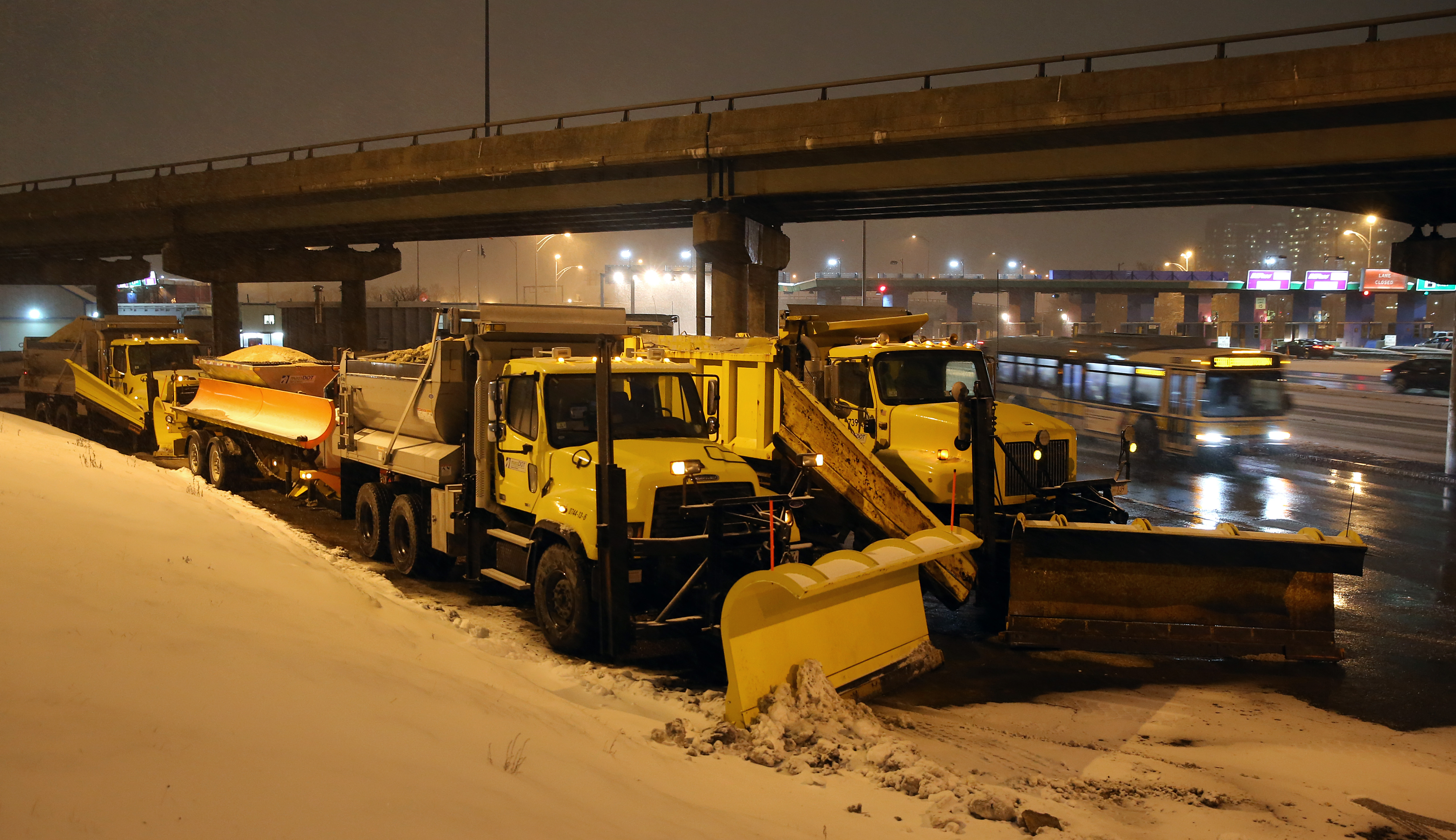 Plows waited at the Allston toll booths Mondayevening.