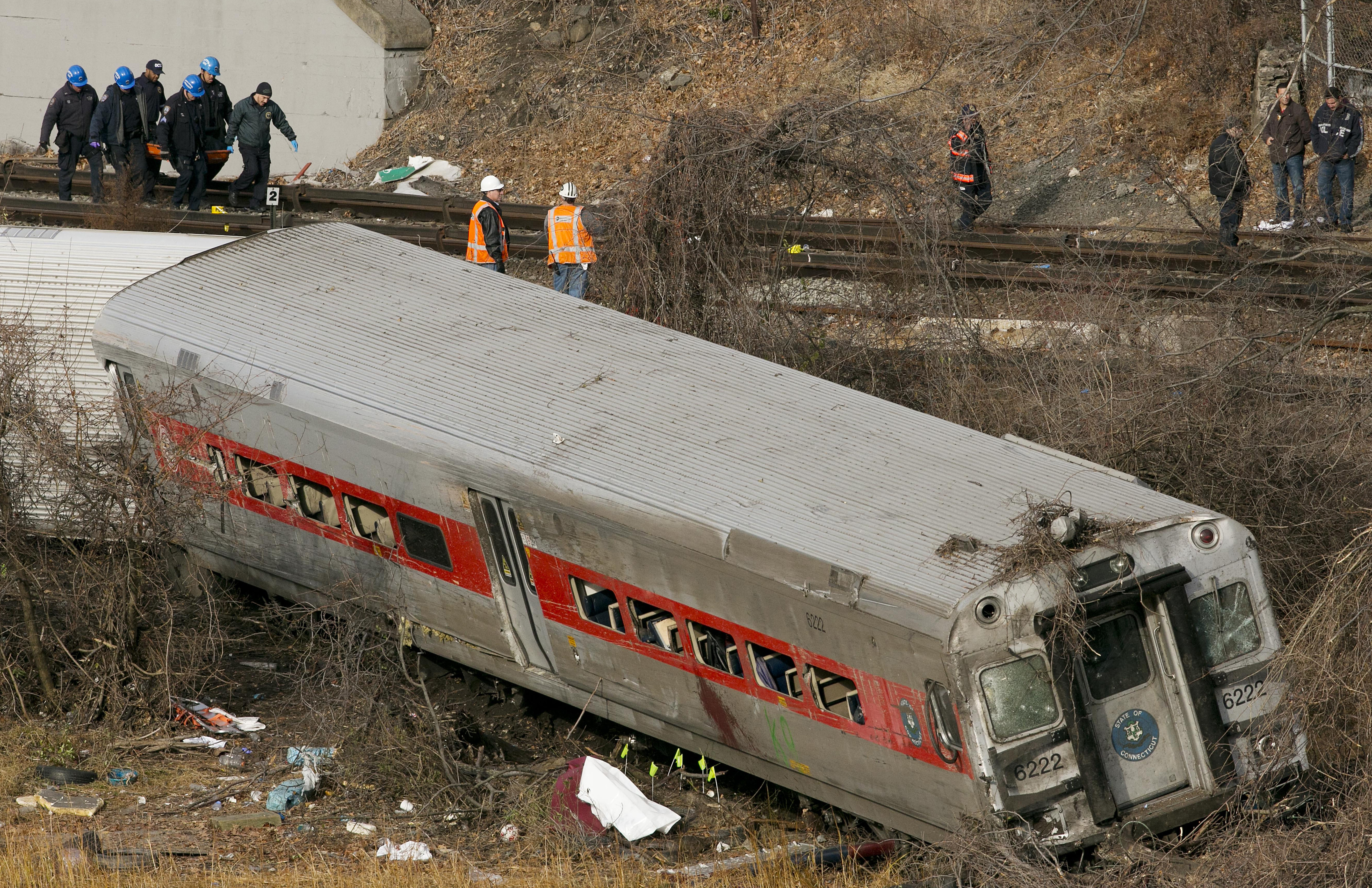 Personnel removed the body of a victim from the site of a train derailment in 2013 in New York City.
