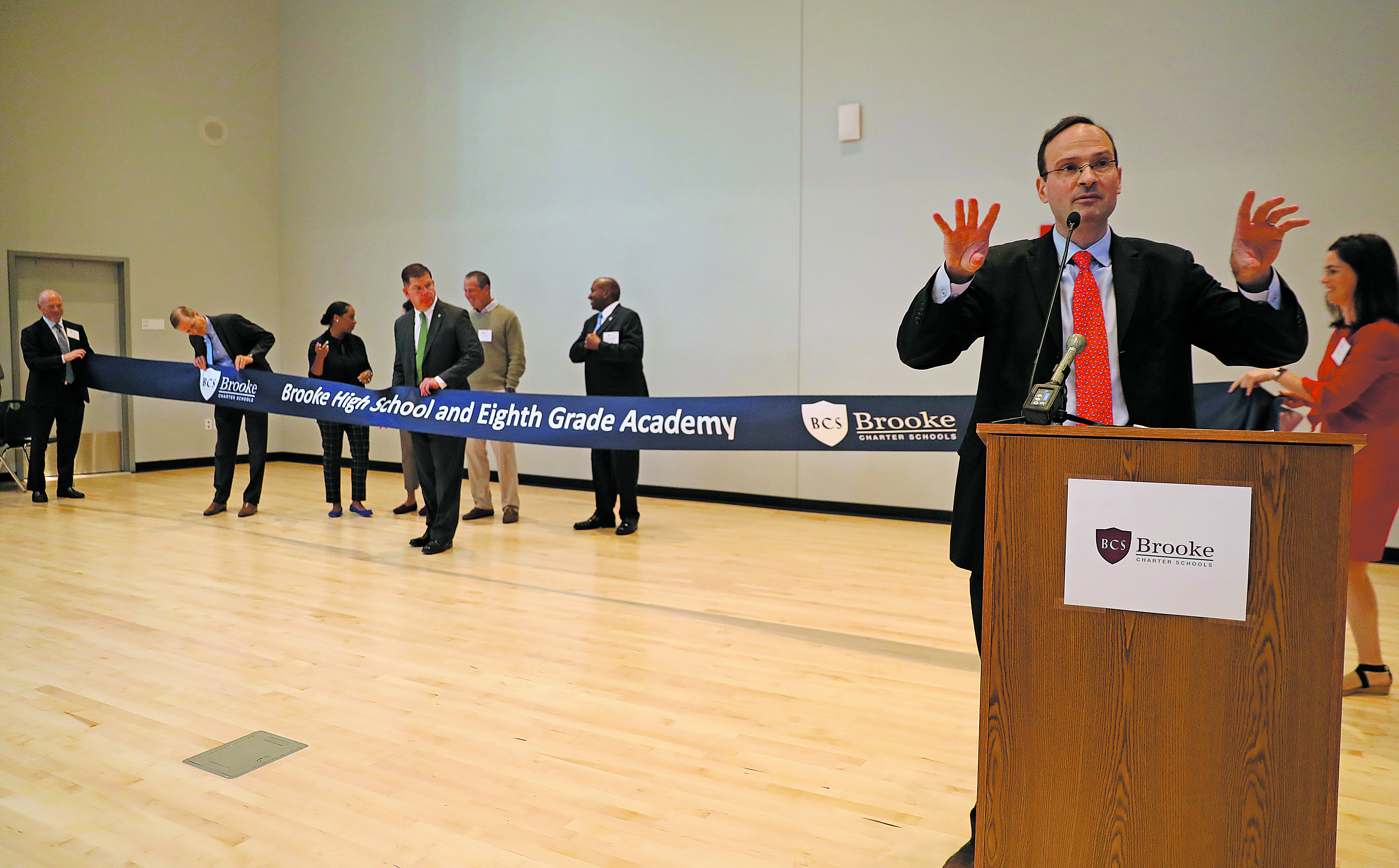 Jon Clark, co-director of Brooke Charter Schools, tried to organize the ribbon cutting ceremony at the new school.