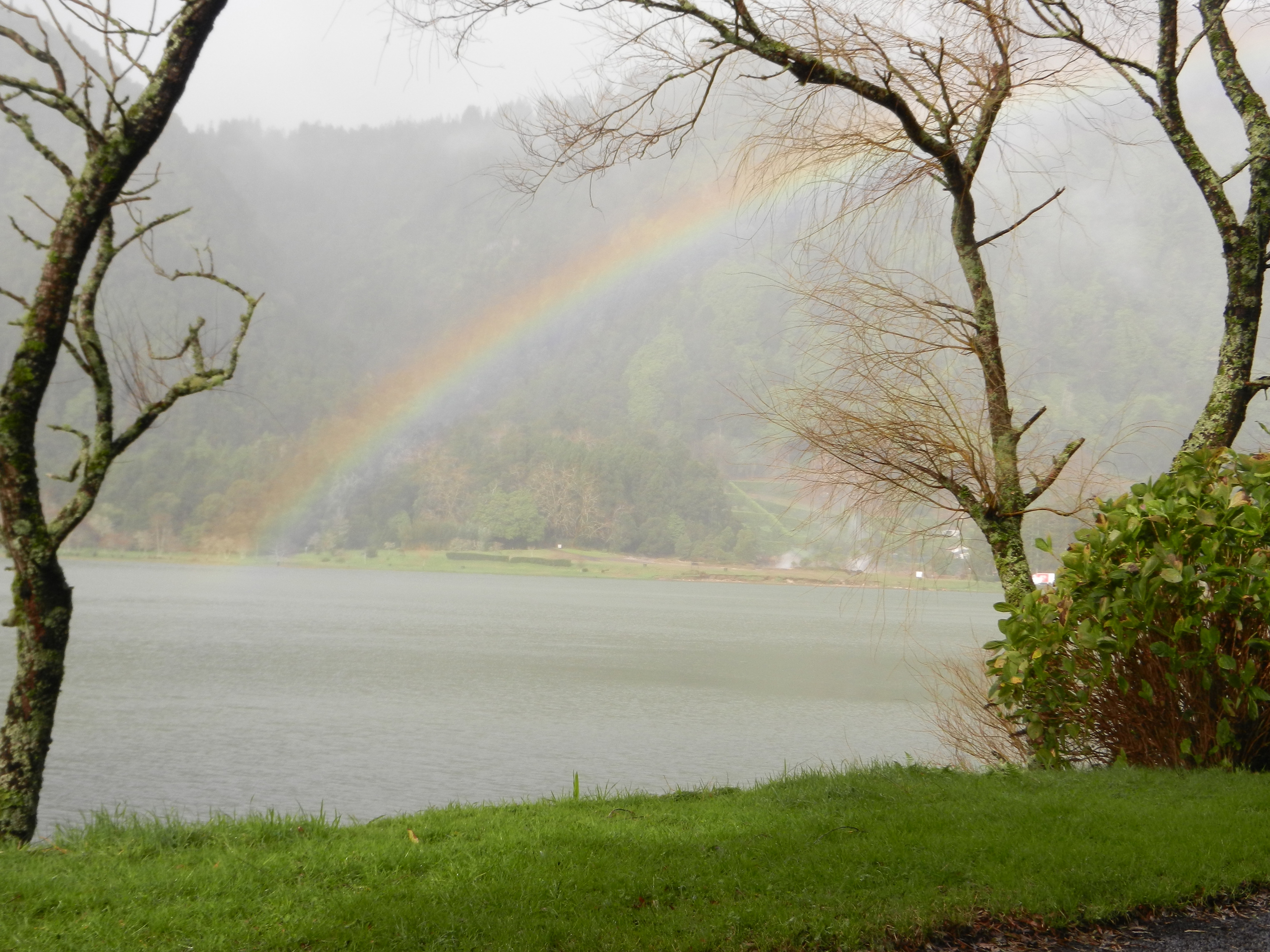 LAKE EFFECT SHOW A rainbow forms over Lagoa das Furnas, a volcanic crater lake on Sao Miguel.